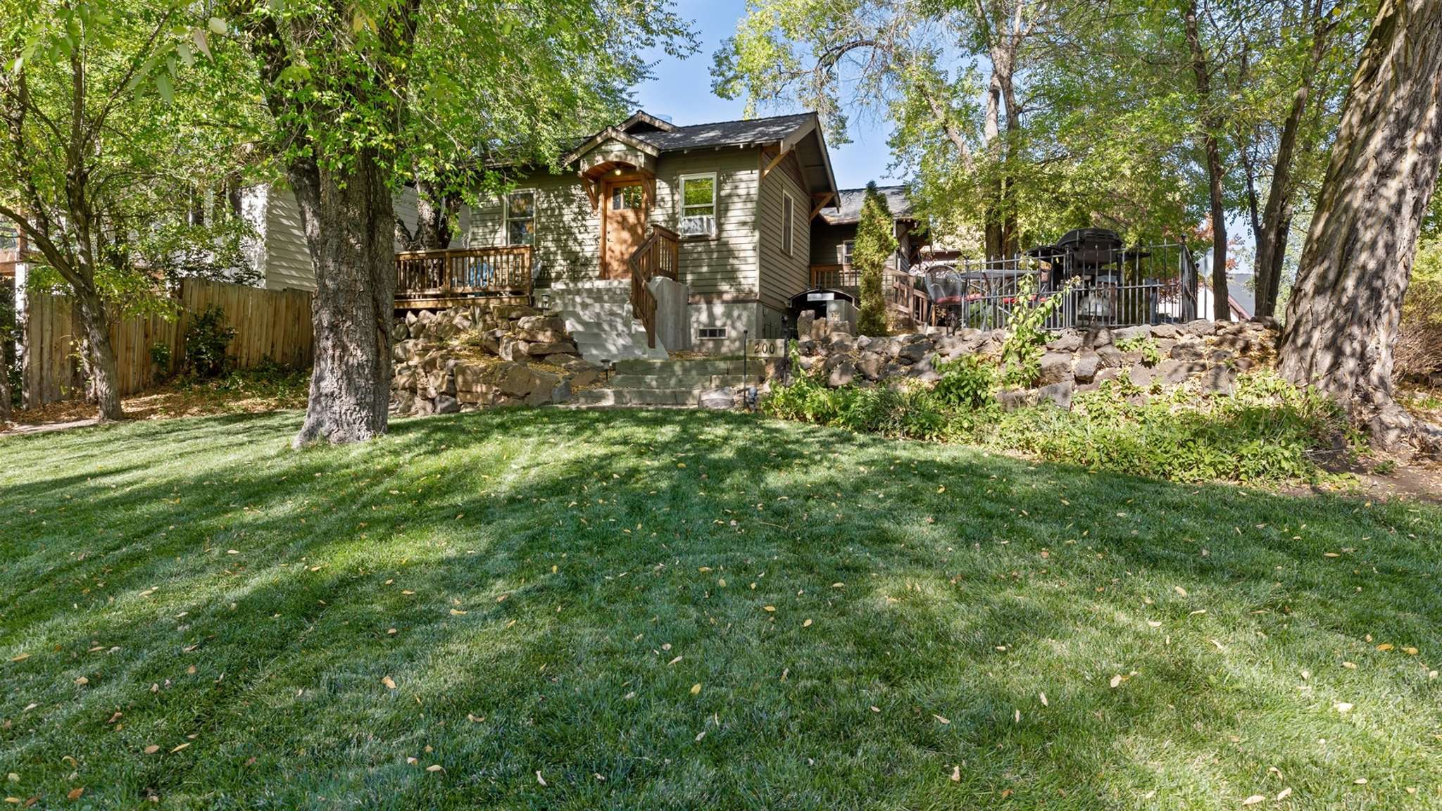 Expansive lawn view of the property, showcasing both the cottage and the studio. 