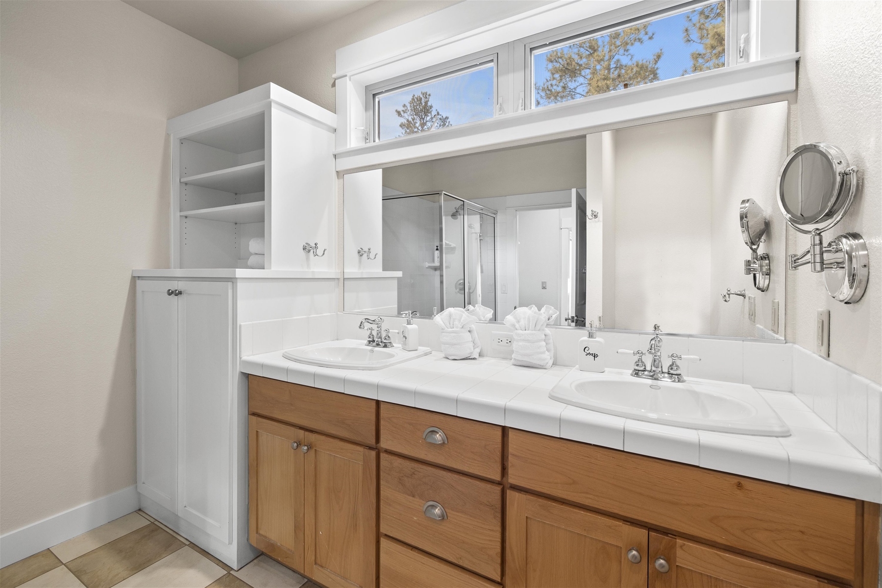 Main suite bathroom with dual sinks and shower.