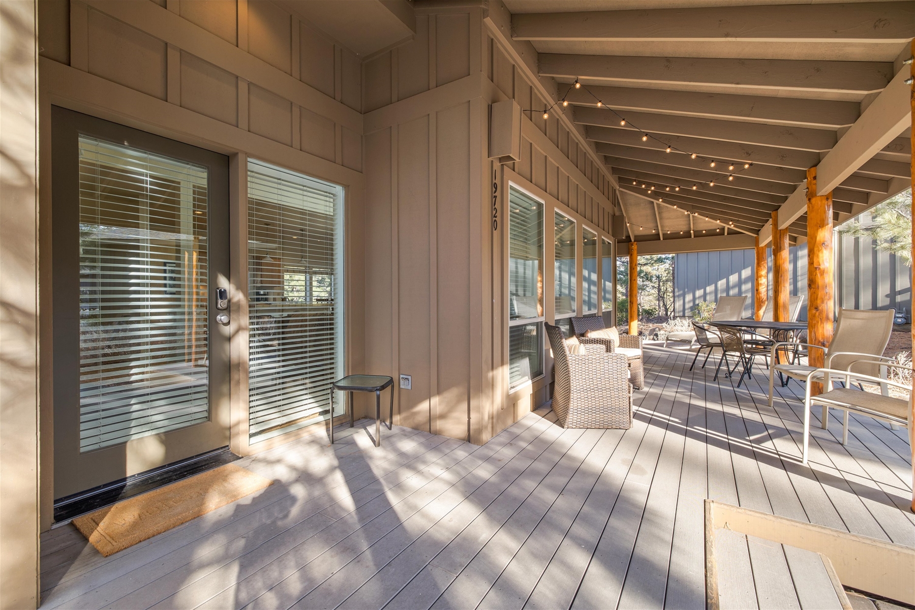 Expansive wrap around deck with seated dining and lounge chairs.