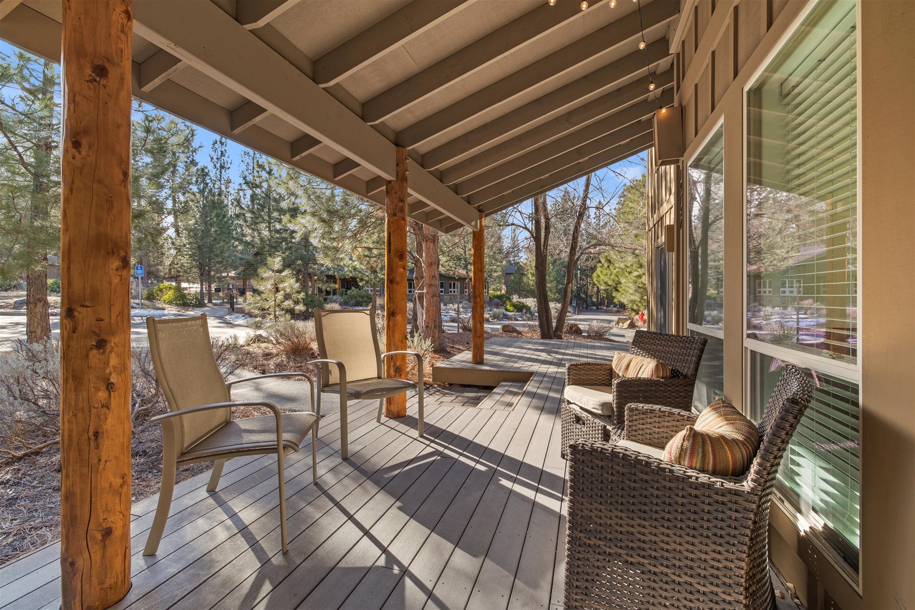 Expansive wrap around deck with seated dining and lounge chairs.
