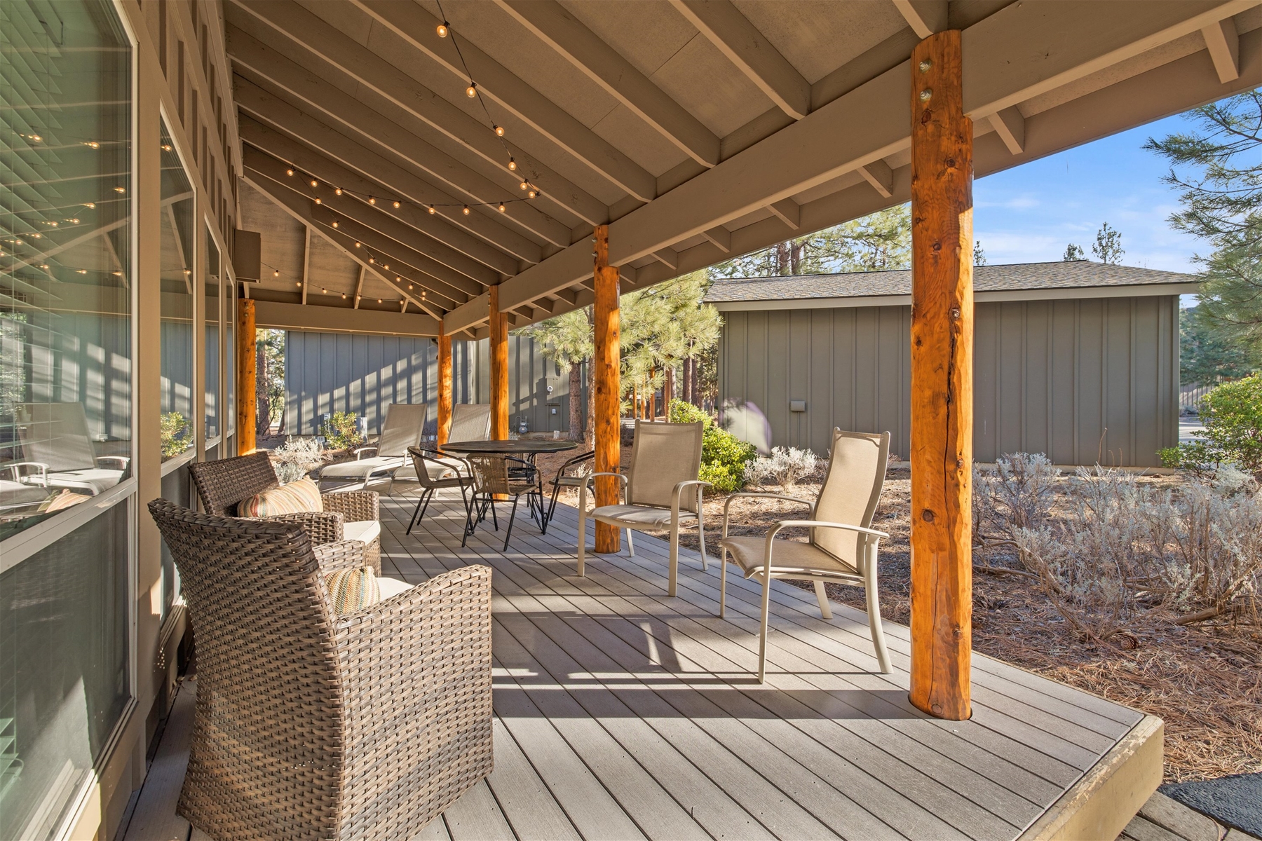 Expansive wrap around deck with seated dining and lounge chairs.