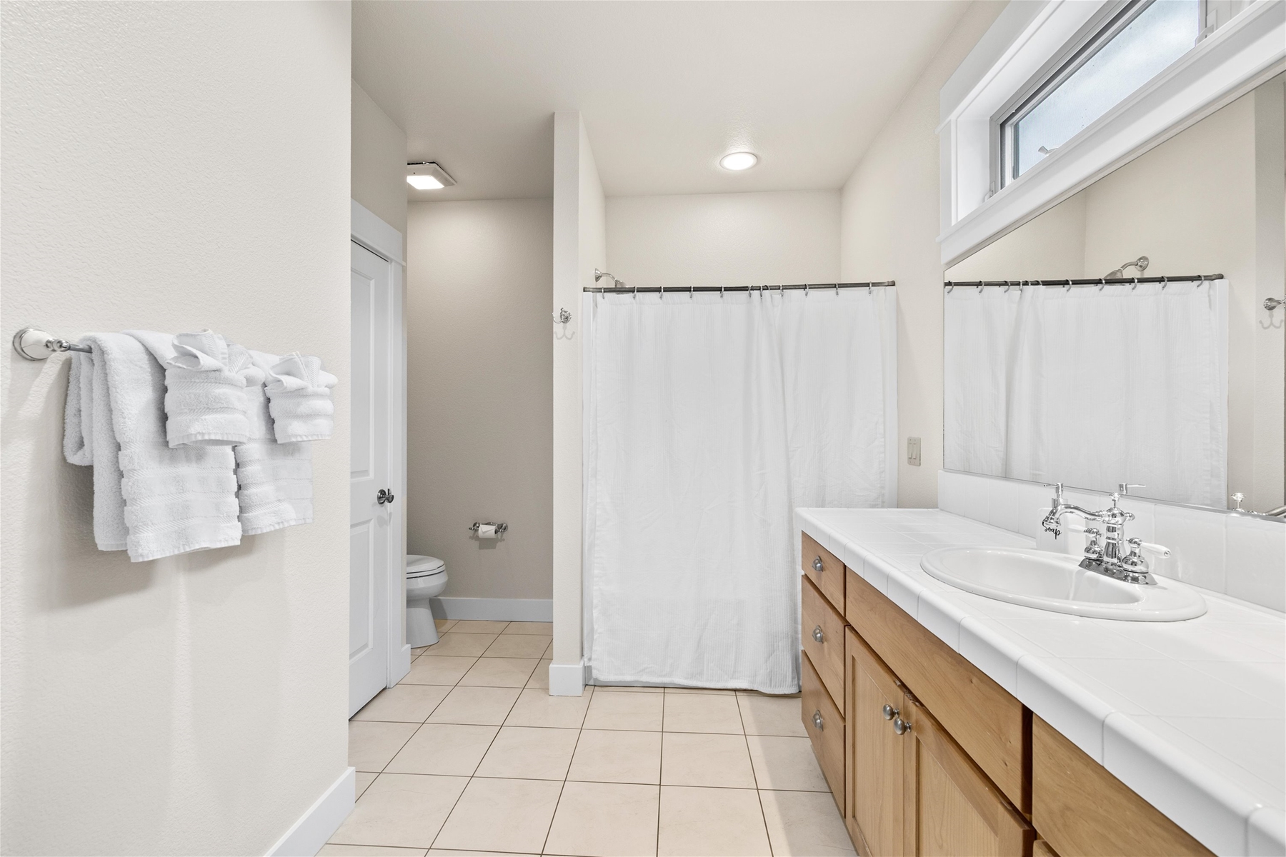 Spacious guest bathroom with tub and shower combo for added flexibility.