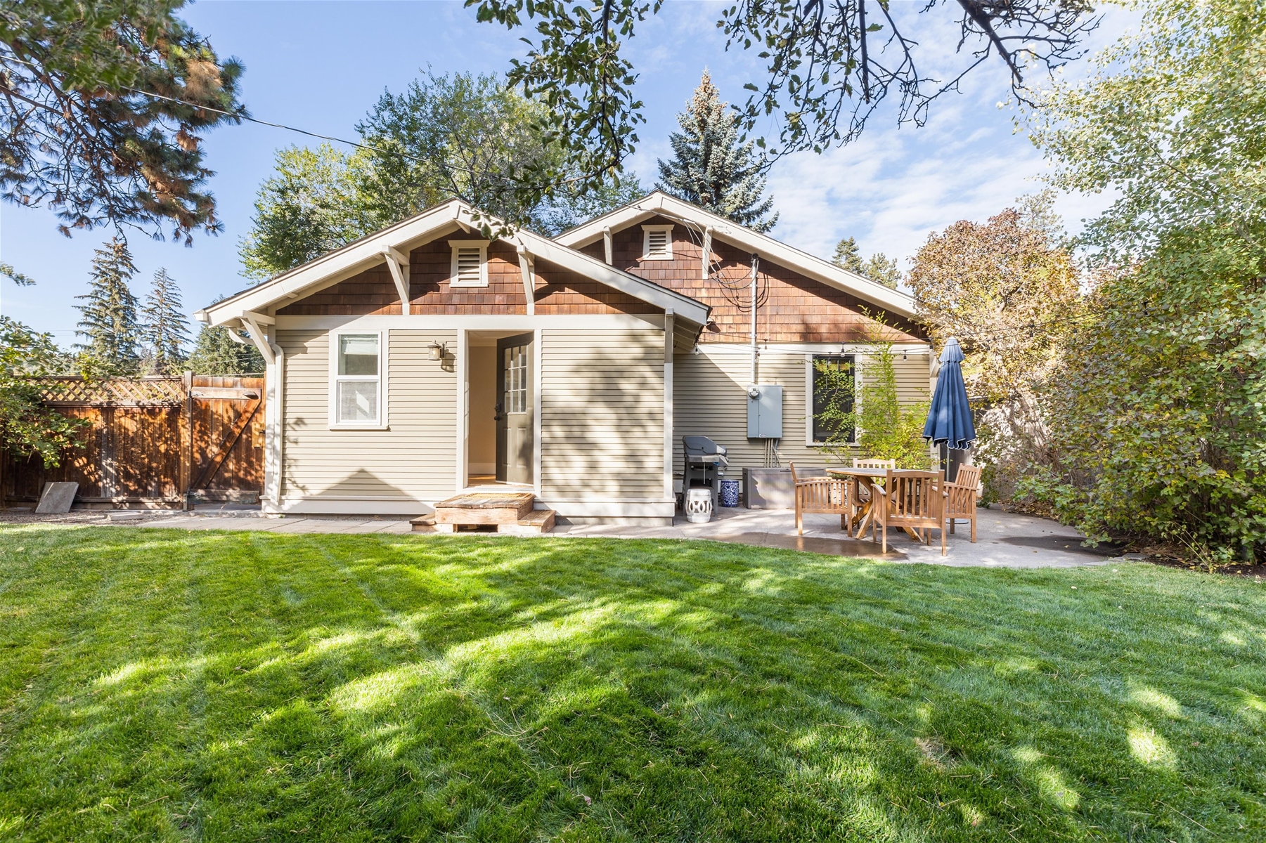 Outdoor patio with a propane BBQ grill and seating for 4. 