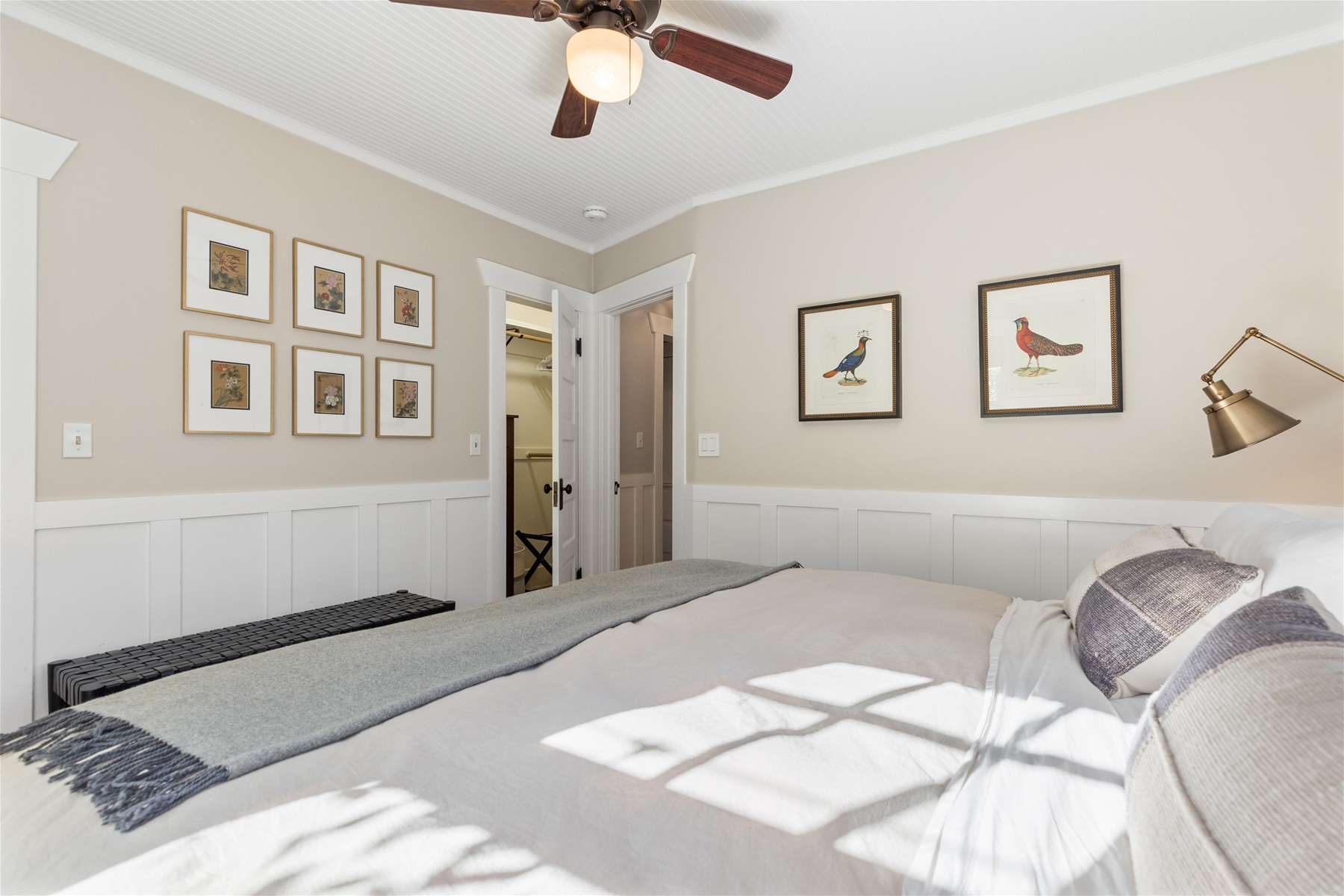 King guest suite with ceiling fan and dresser in closet. 