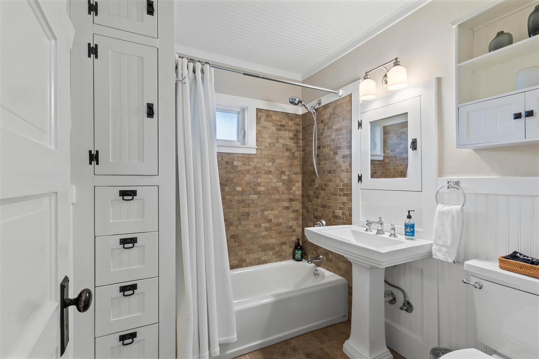 Guest full bathroom with tiled shower. 