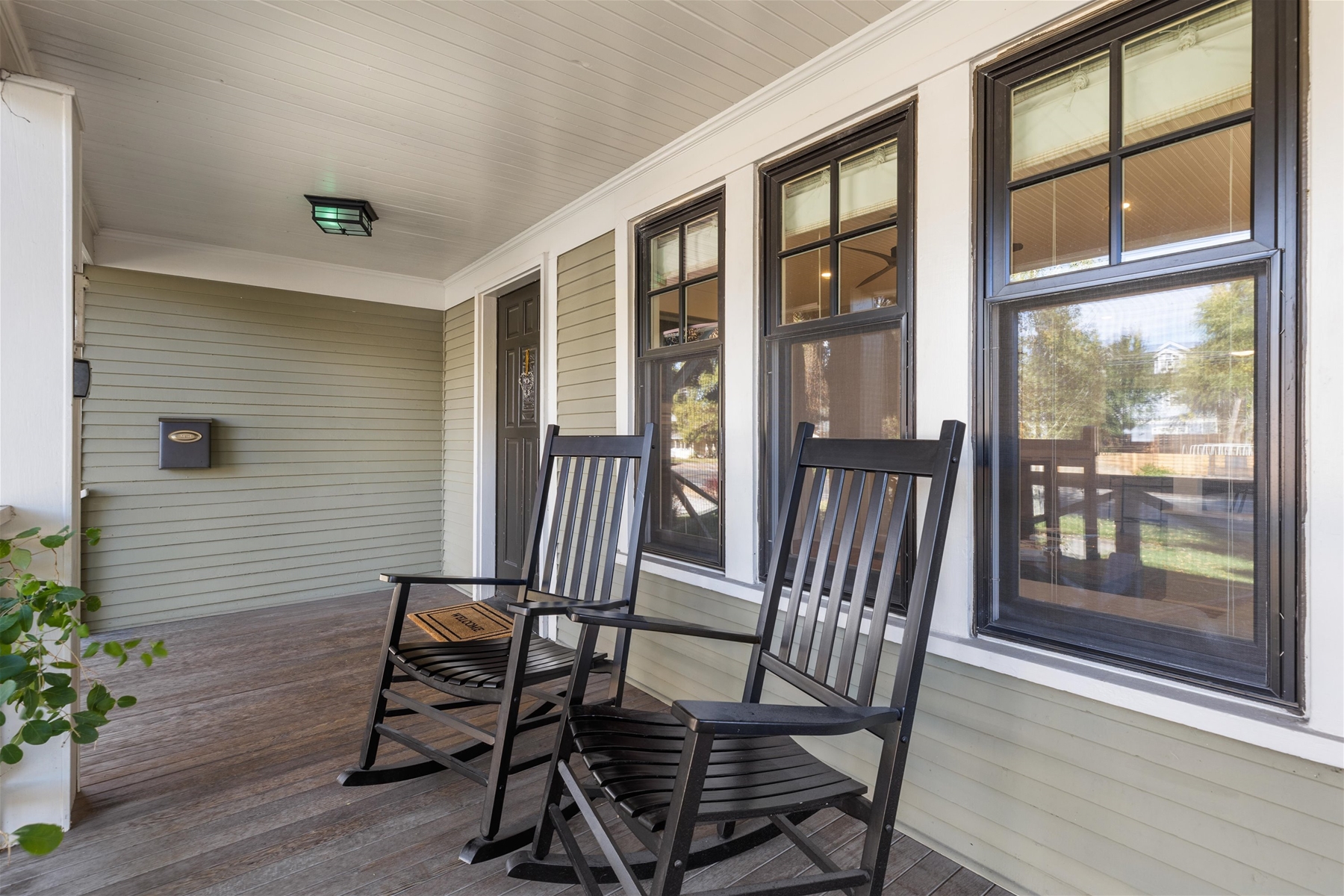 Covered porch with two rocking chairs. 