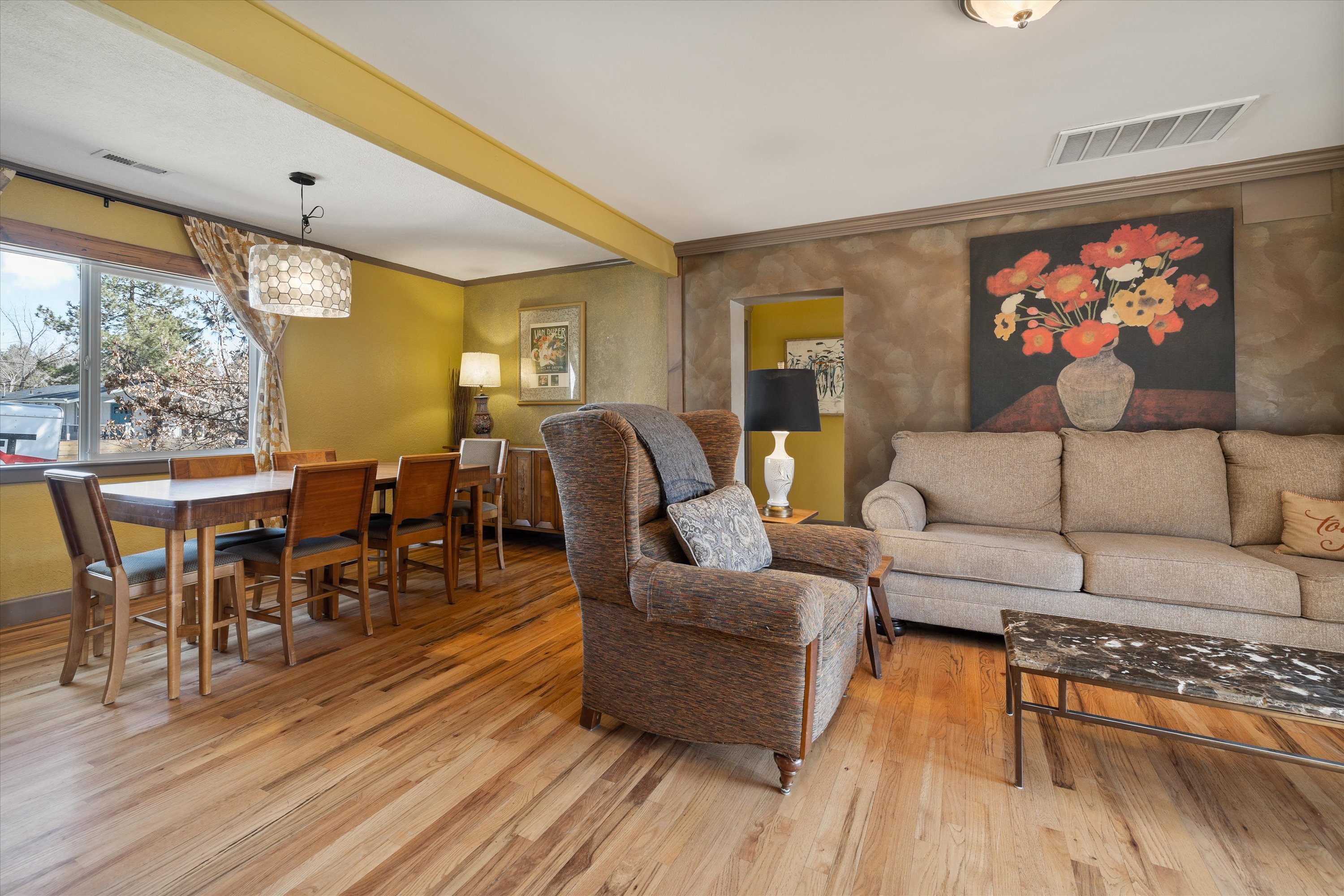 Wood flooring throughout the home – comfortable living room and formal seated dining for six. 