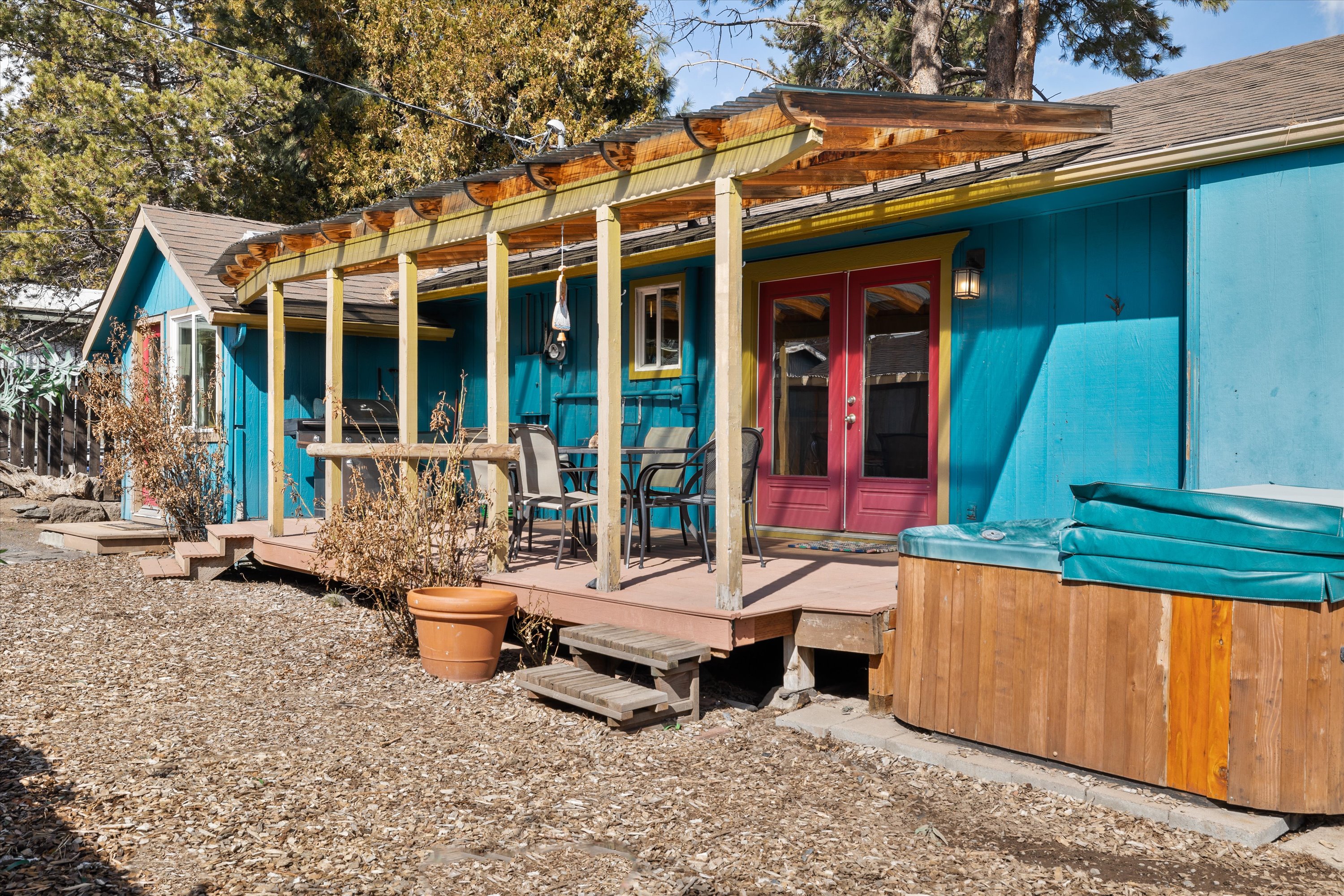 View of the home from the backyard – Deck includes a hot tub, BBQ grill, and outdoor dining. 