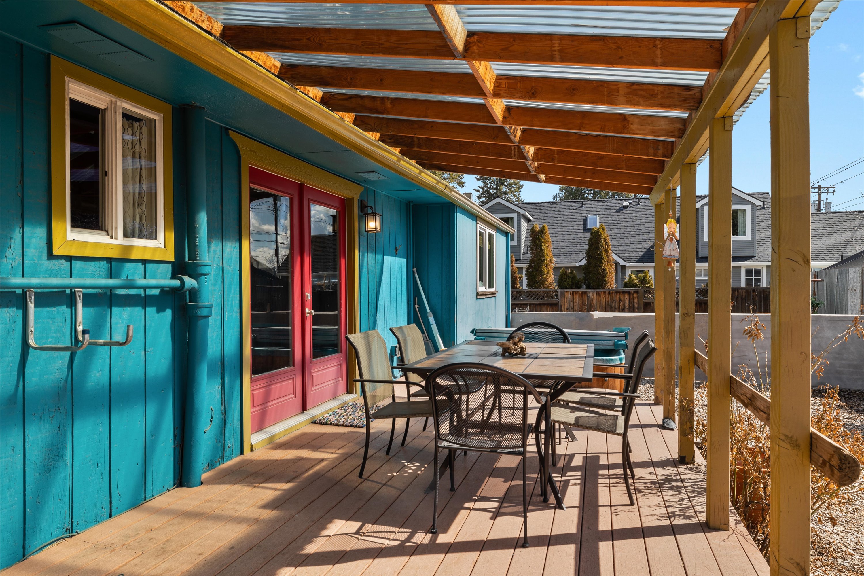 Covered deck with a propane BBQ grill and outdoor dining for six.