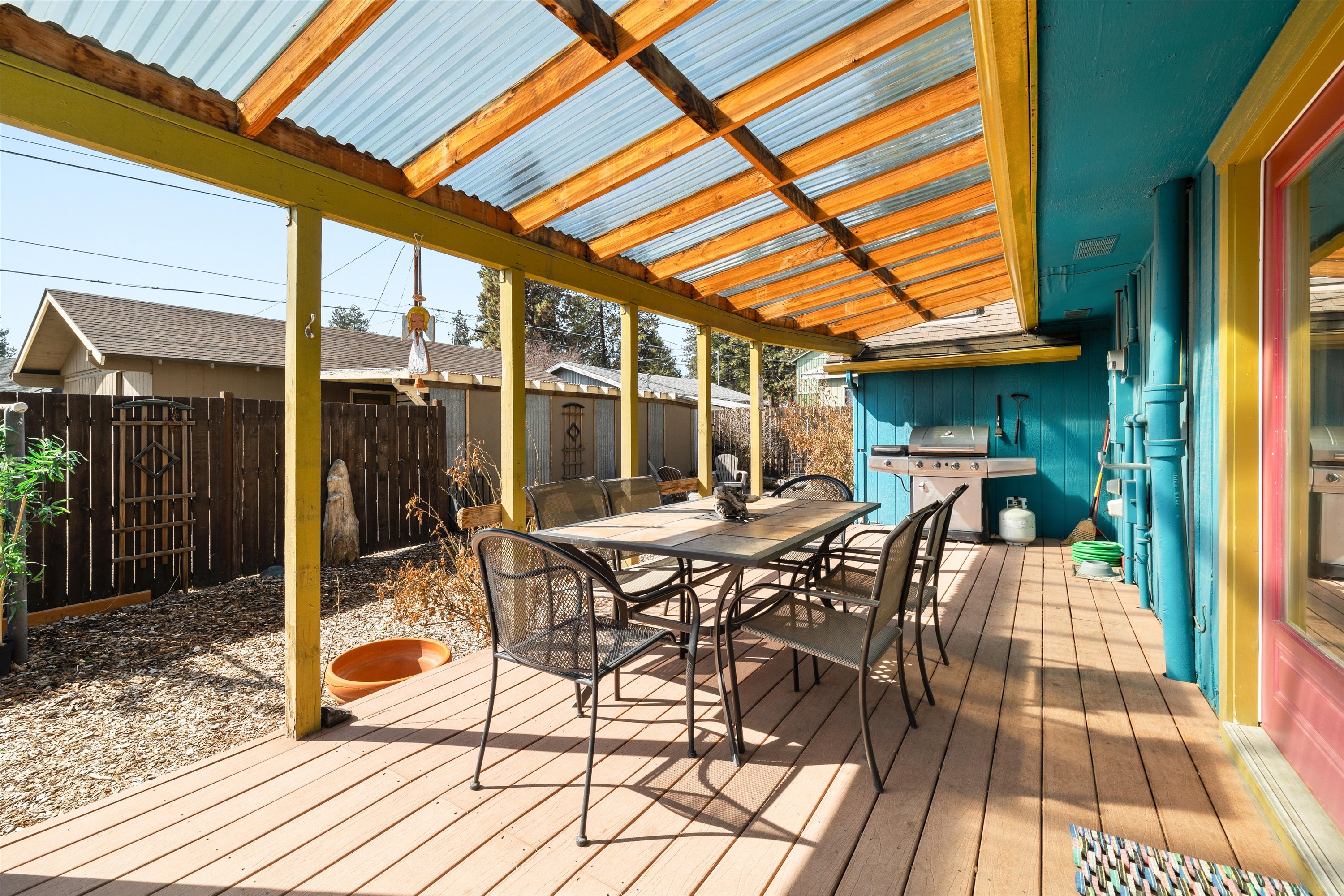 Covered deck with a propane BBQ grill and outdoor dining for six.