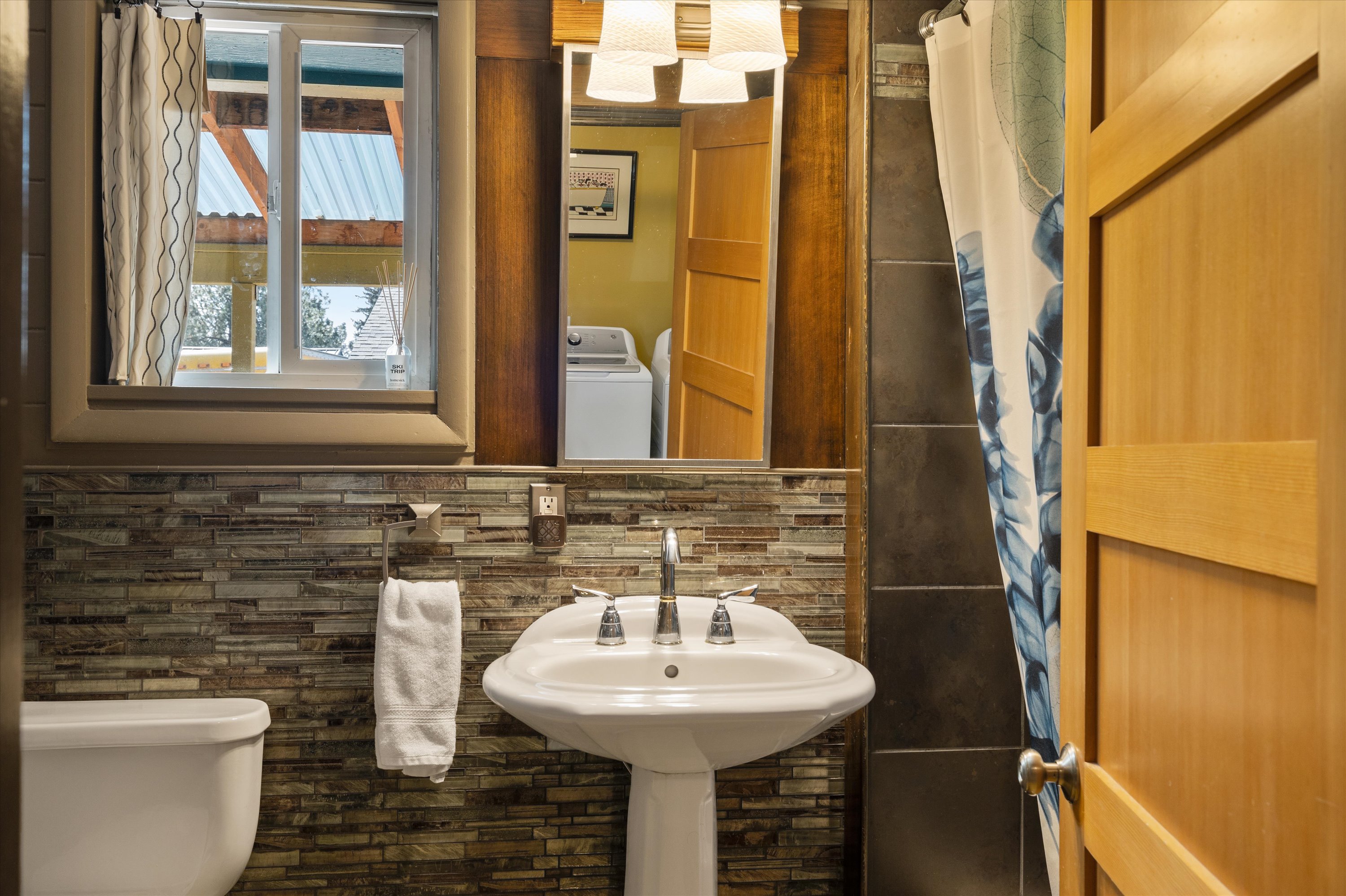 Full bathroom with convenient tub/shower combo and modern finishes.