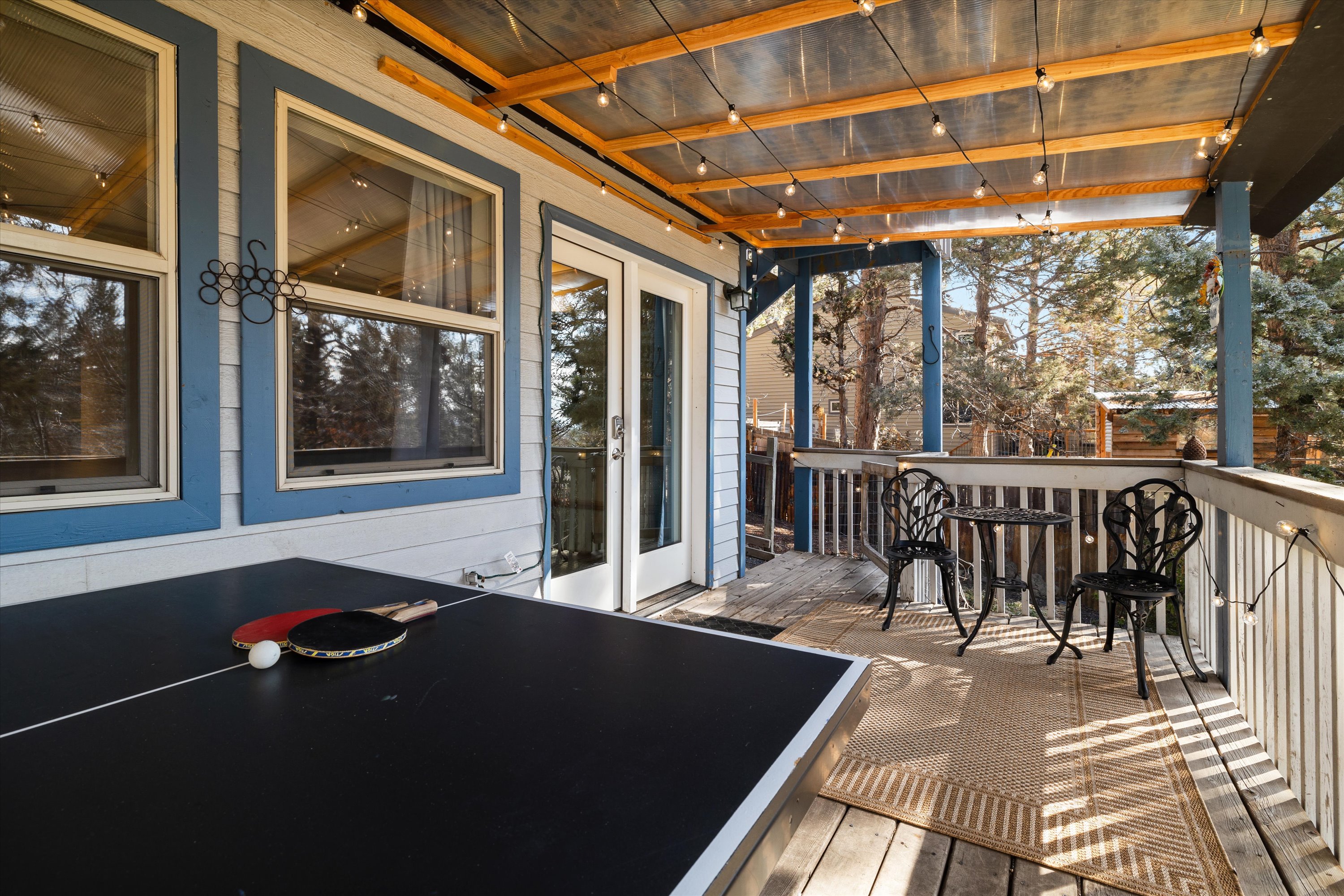 Covered deck with ping pong and outdoor seating. 