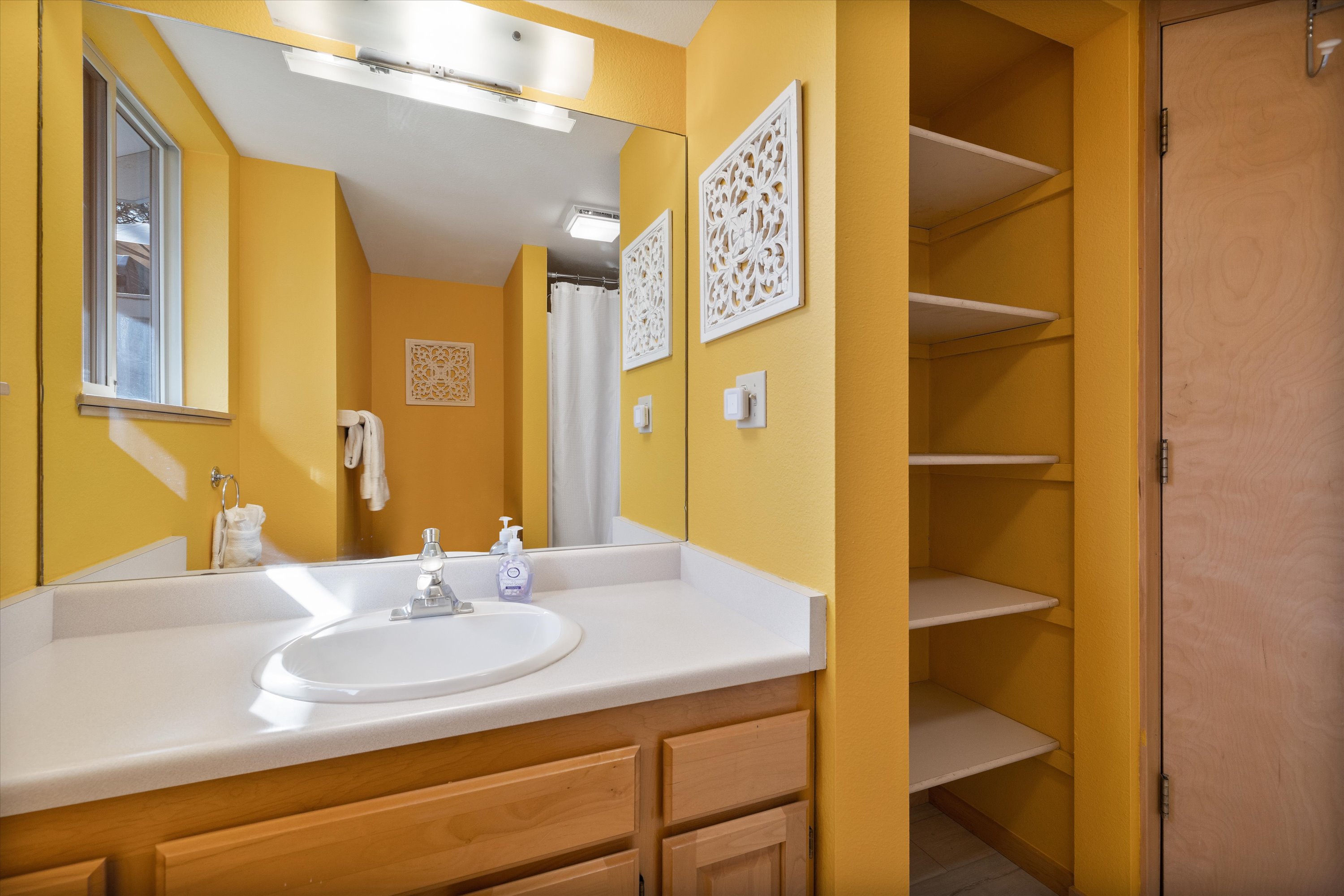 Clean and functional bathroom featuring a tub/shower combination – Main level. 