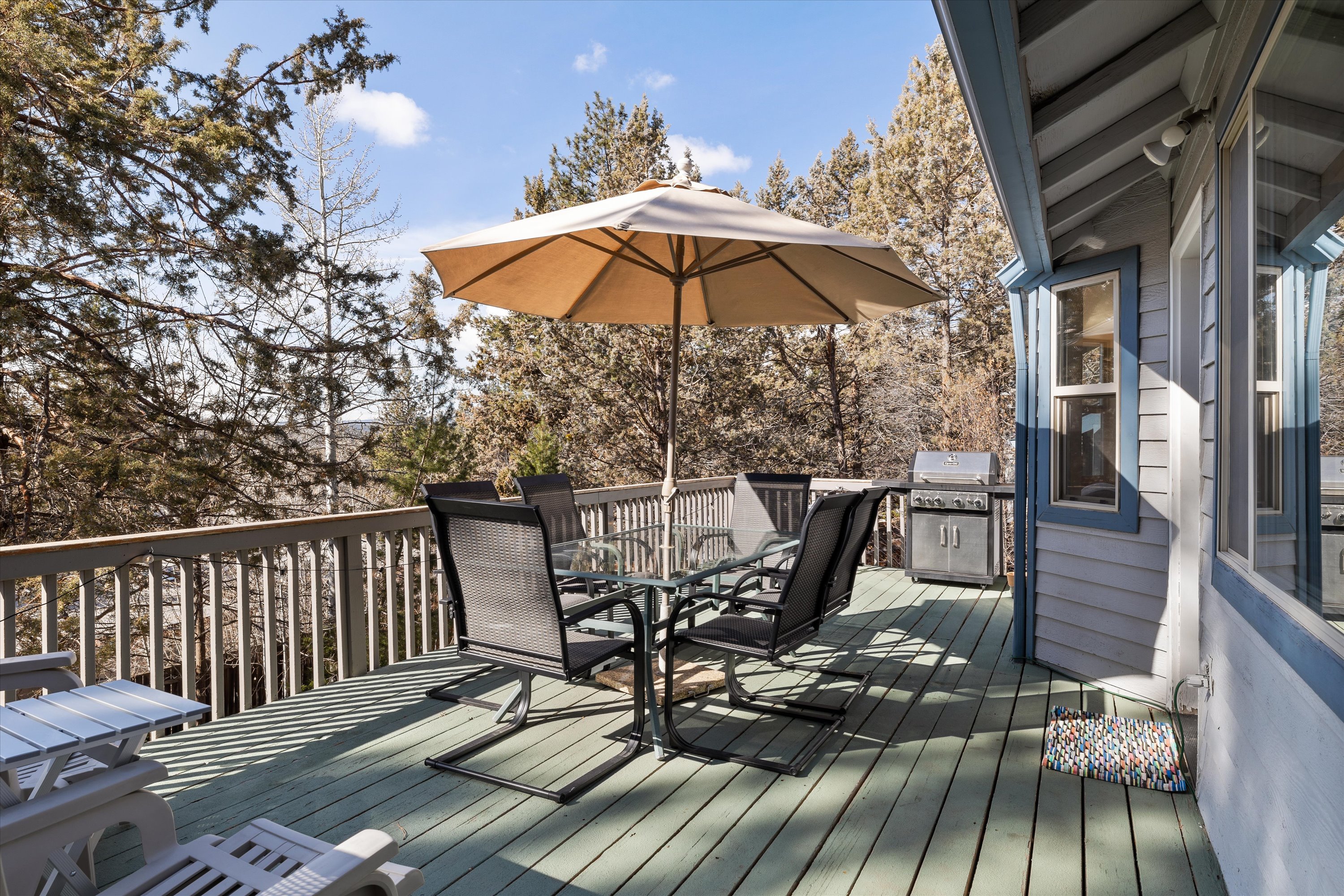 Upper deck accessed from living room. Outdoor dining, BBQ grill, and beautiful views. 