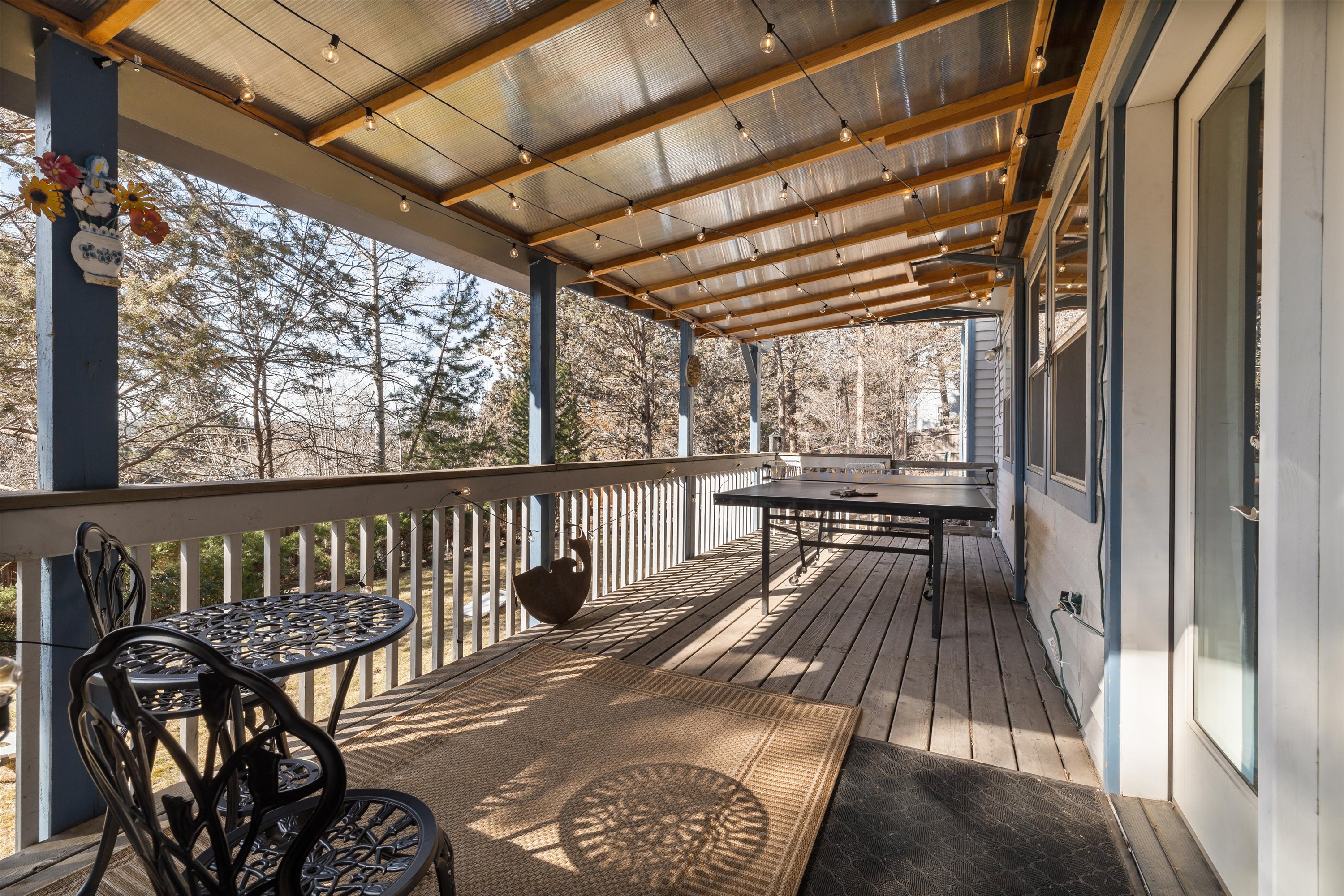 Covered deck with ping pong and outdoor seating. 
