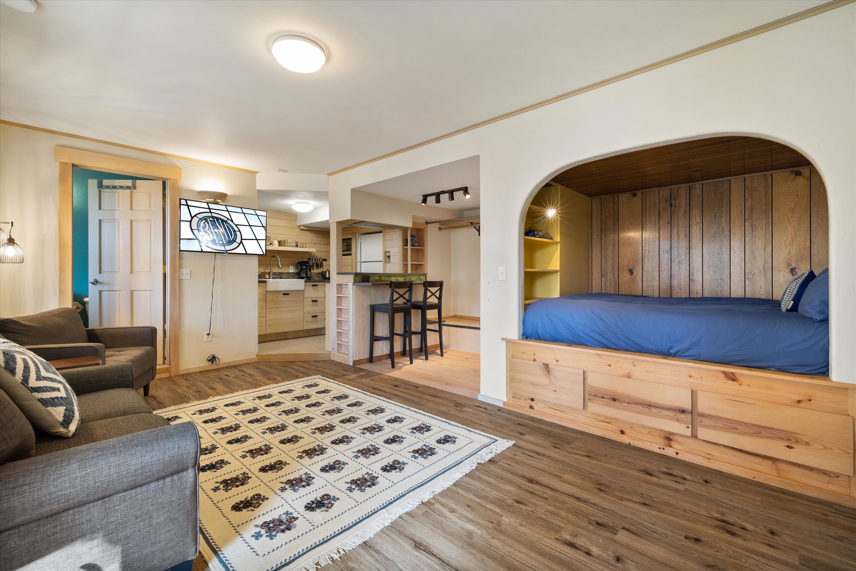 Private studio with queen bed, kitchenette, smart TV, and full bathroom – Lower level.