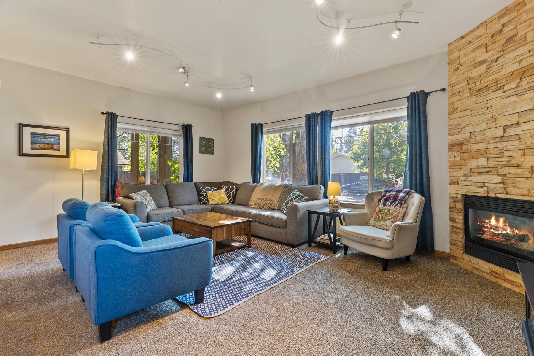 Cozy up in style- this living room includes a natural gas fireplace, a smart TV, and an X-Box with games. 