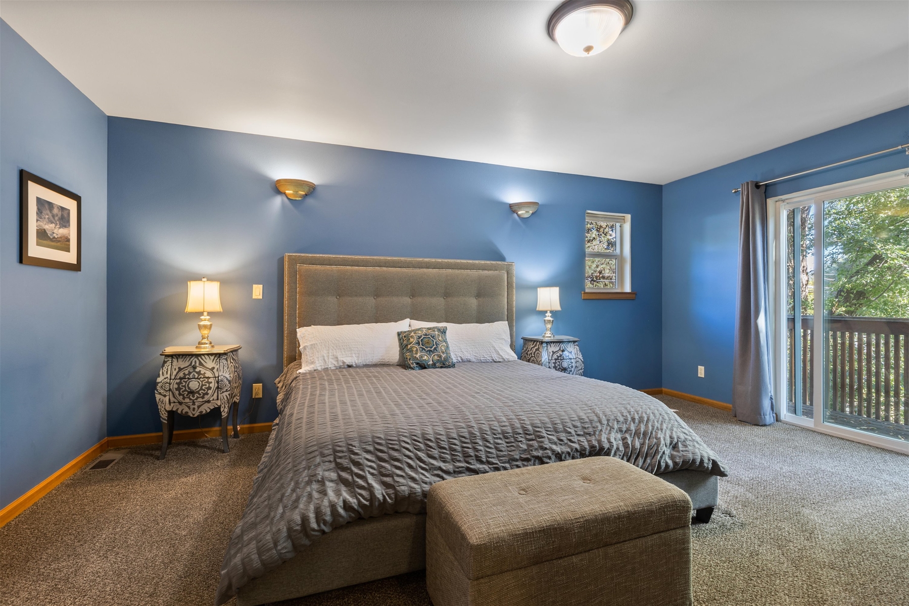 Unwind in this spacious king main suite with a Smart TV and private balcony – Upper level. 