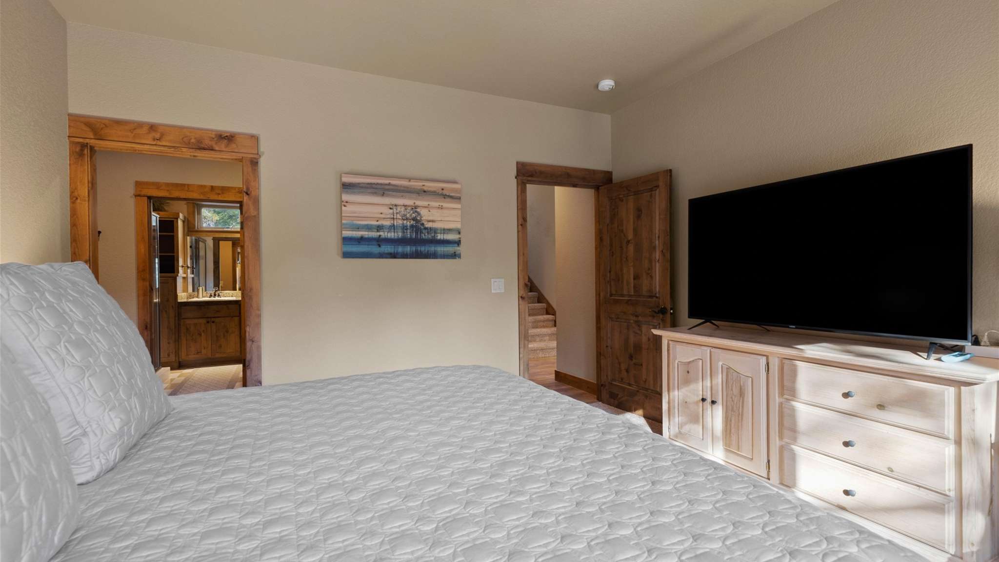 King bed, walk-in closet, ensuite bathroom with dual sinks and shower