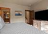 King bed, walk-in closet, ensuite bathroom with dual sinks and shower