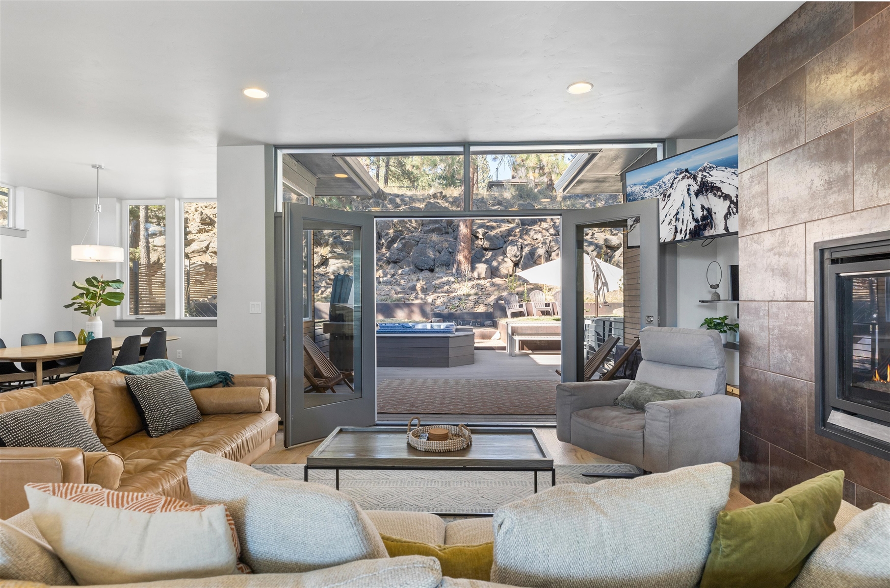 Cozy up in style! This living room is perfect for relaxation and gathering, with direct views of the backyard.
