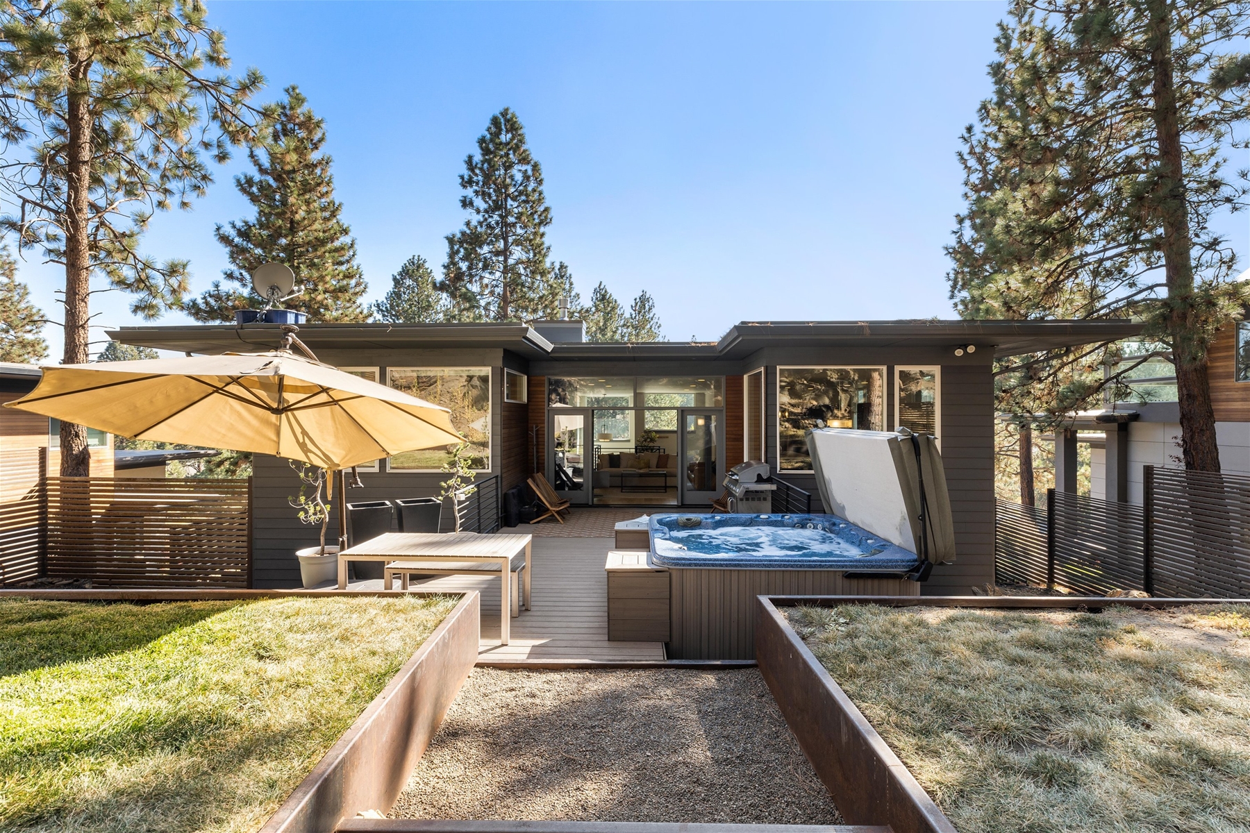 Our large deck in the backyard includes BBQ grill, outdoor dining area, private hot tub, and a fire pit. 
