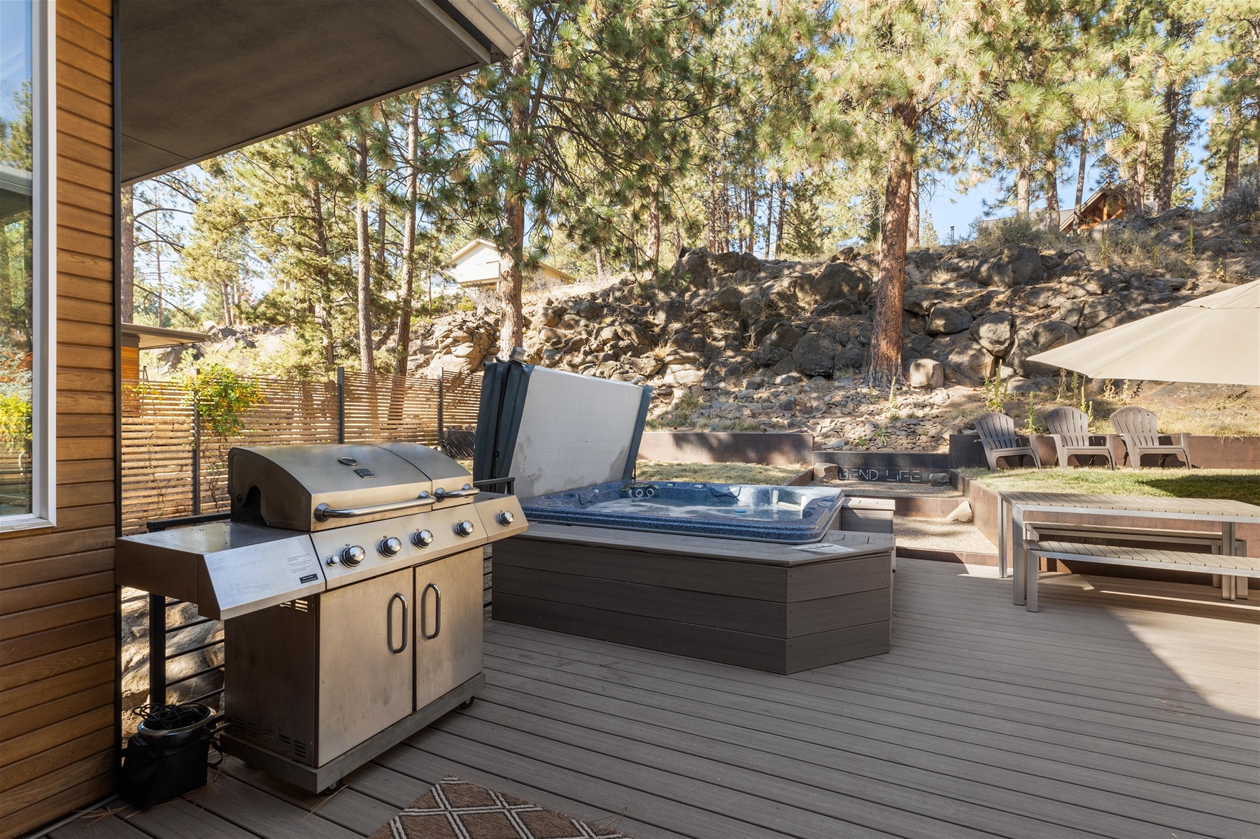 Our large deck in the backyard includes BBQ grill, outdoor dining area, private hot tub, and a fire pit. 