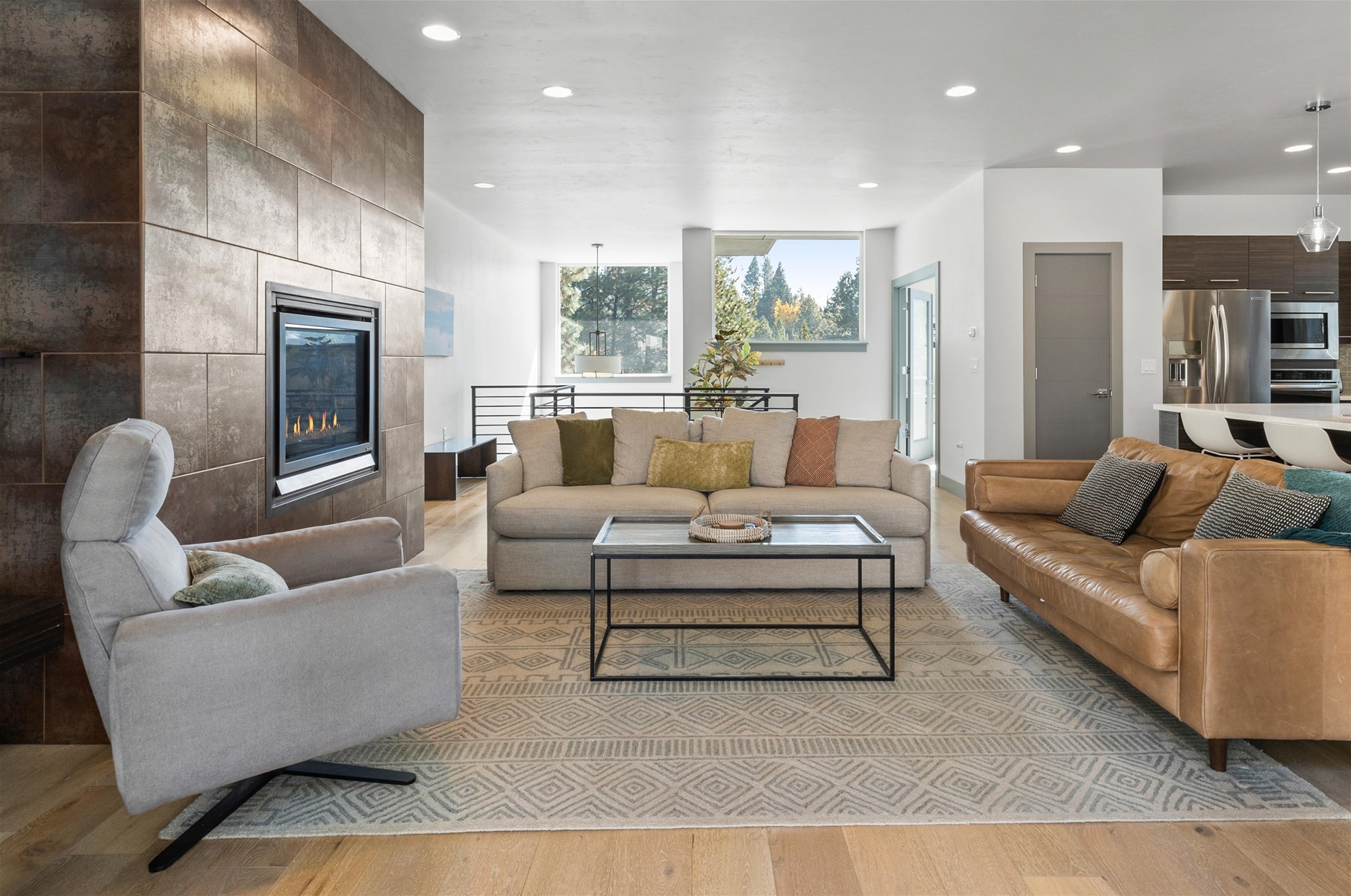 Cozy up in style! This living room is perfect for relaxation and gathering, with direct views of the backyard.
