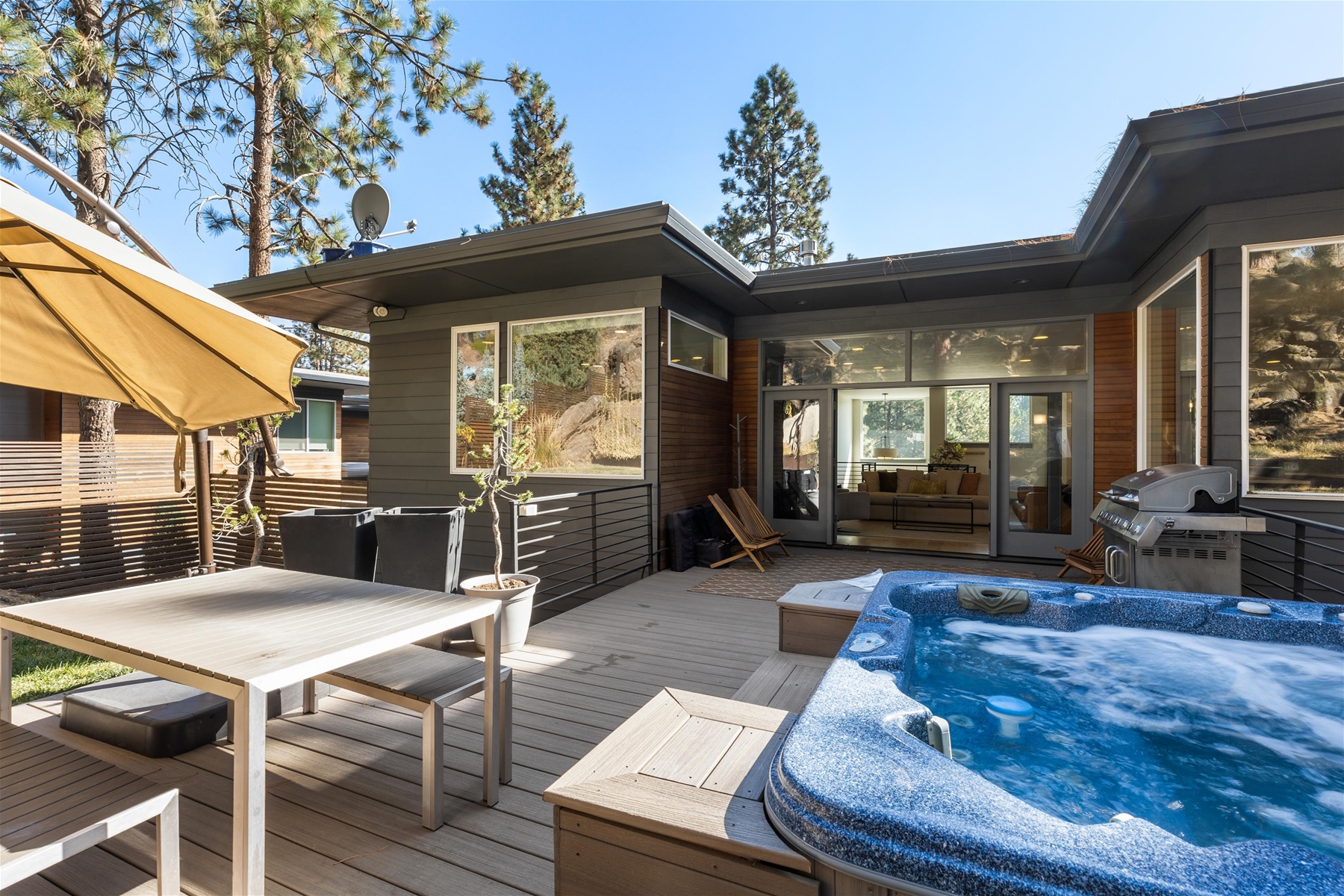 Our large deck in the backyard includes BBQ grill, outdoor dining area, private hot tub, and a fire pit. 