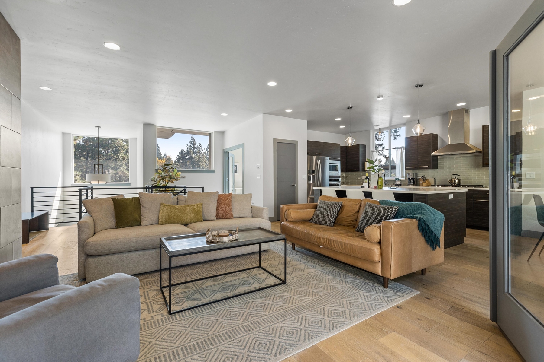 Cozy up in style! This living room is perfect for relaxation and gathering, with direct views of the backyard.
