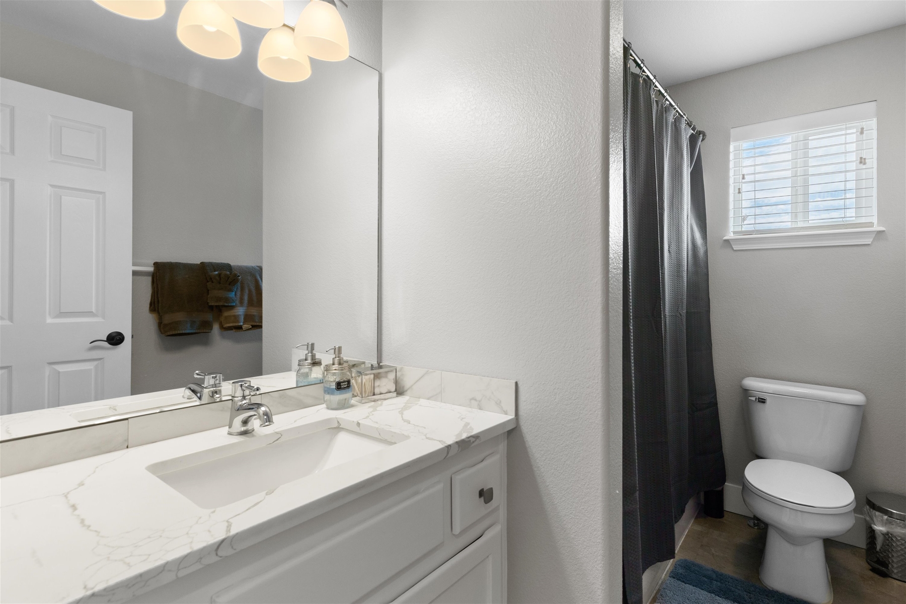 Full guest bathroom with convenient tub/shower combo and modern finishes.