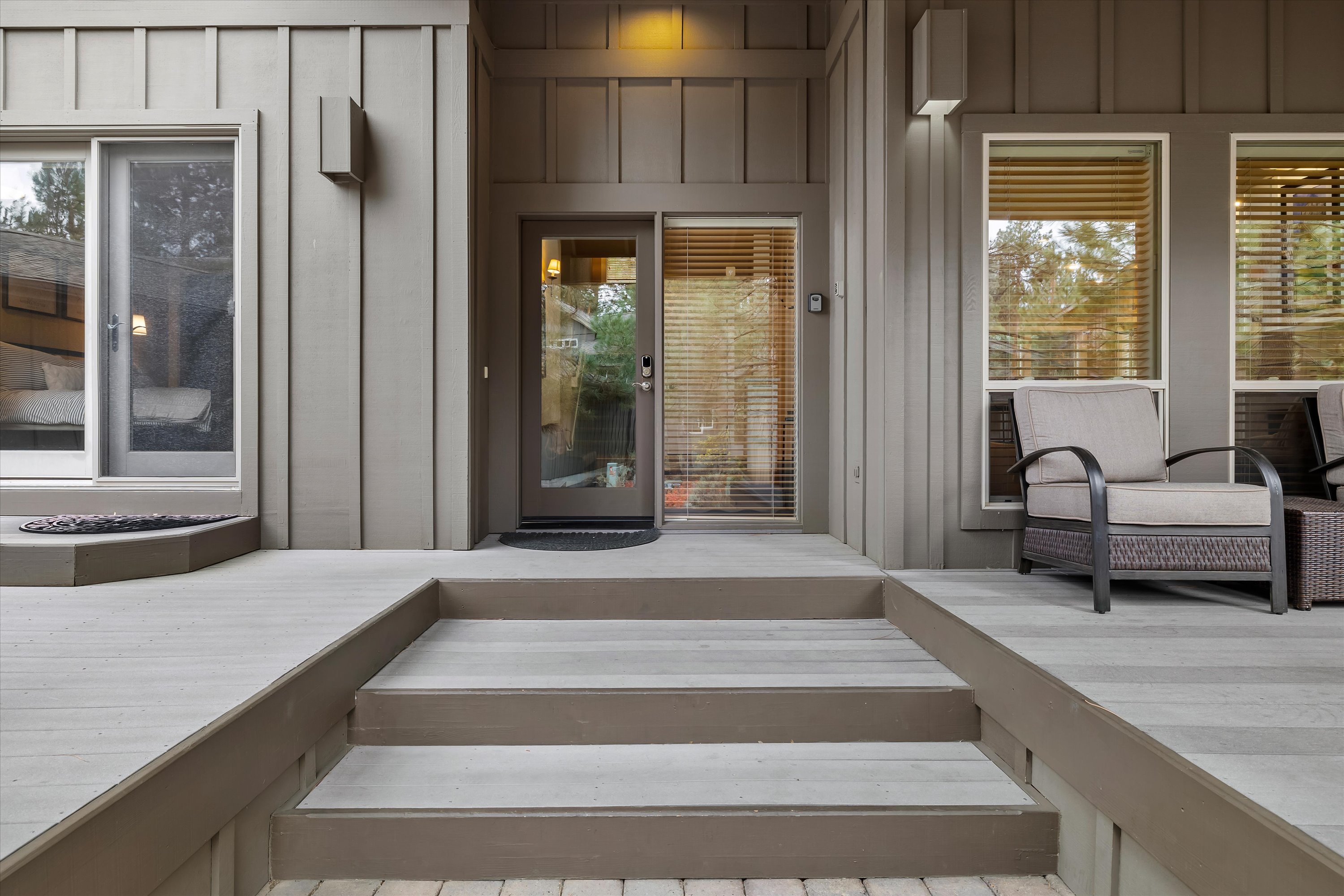 Contemporary exterior with private deck entry steps and outdoor seating — Rafters Court, River Wild, Bend OR.