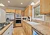 Kitchen with stainless steel refrigerator, microwave, and ample counter space.