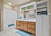 Guest bathroom with tub/shower combo and tile floors.