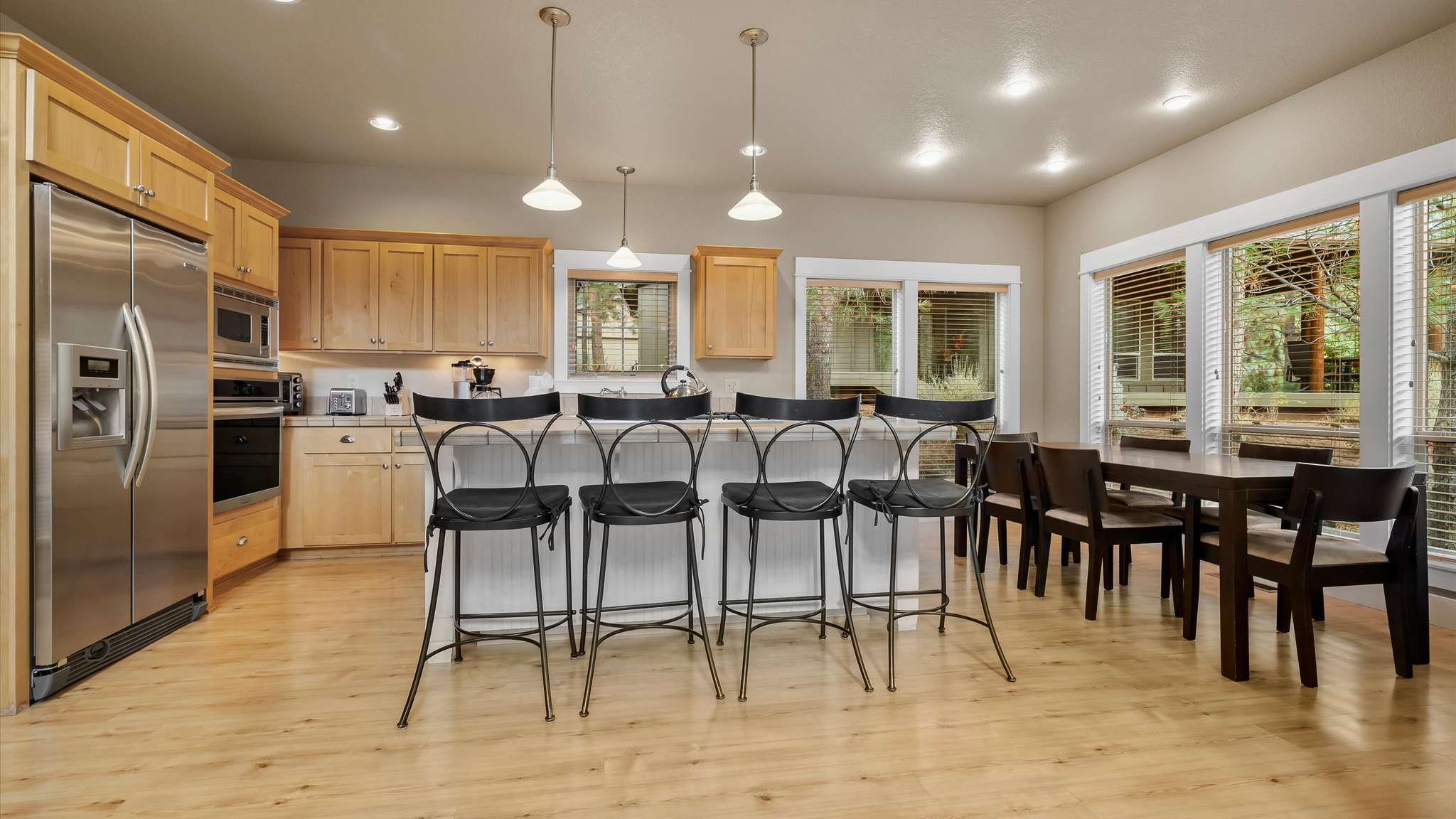 Open kitchen and dining area with breakfast bar seating for 4 and formal dining for 6.