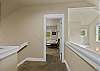 Upper level hallway leading to guest bedrooms.