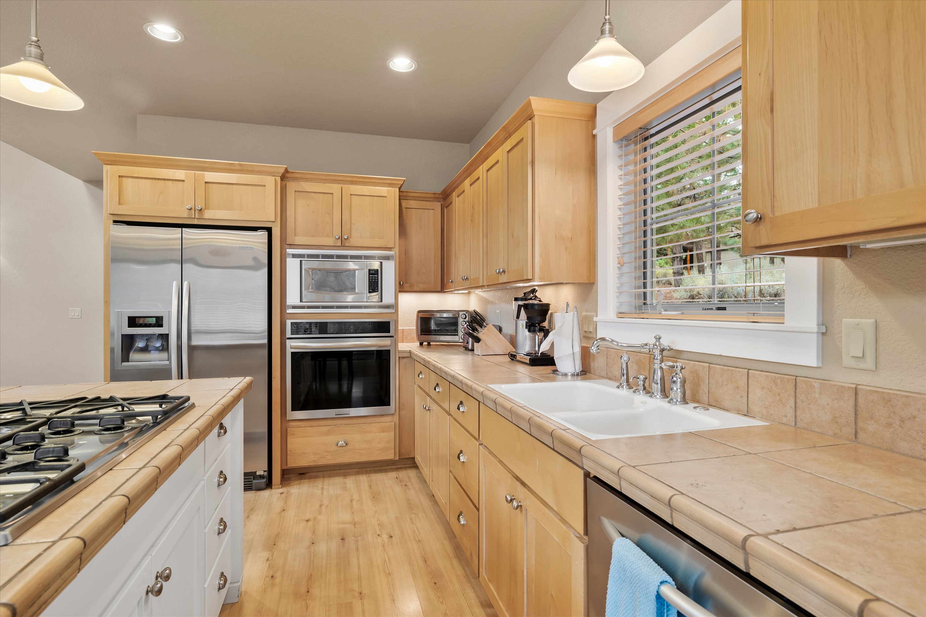 Kitchen with stainless steel refrigerator, microwave, and ample counter space.