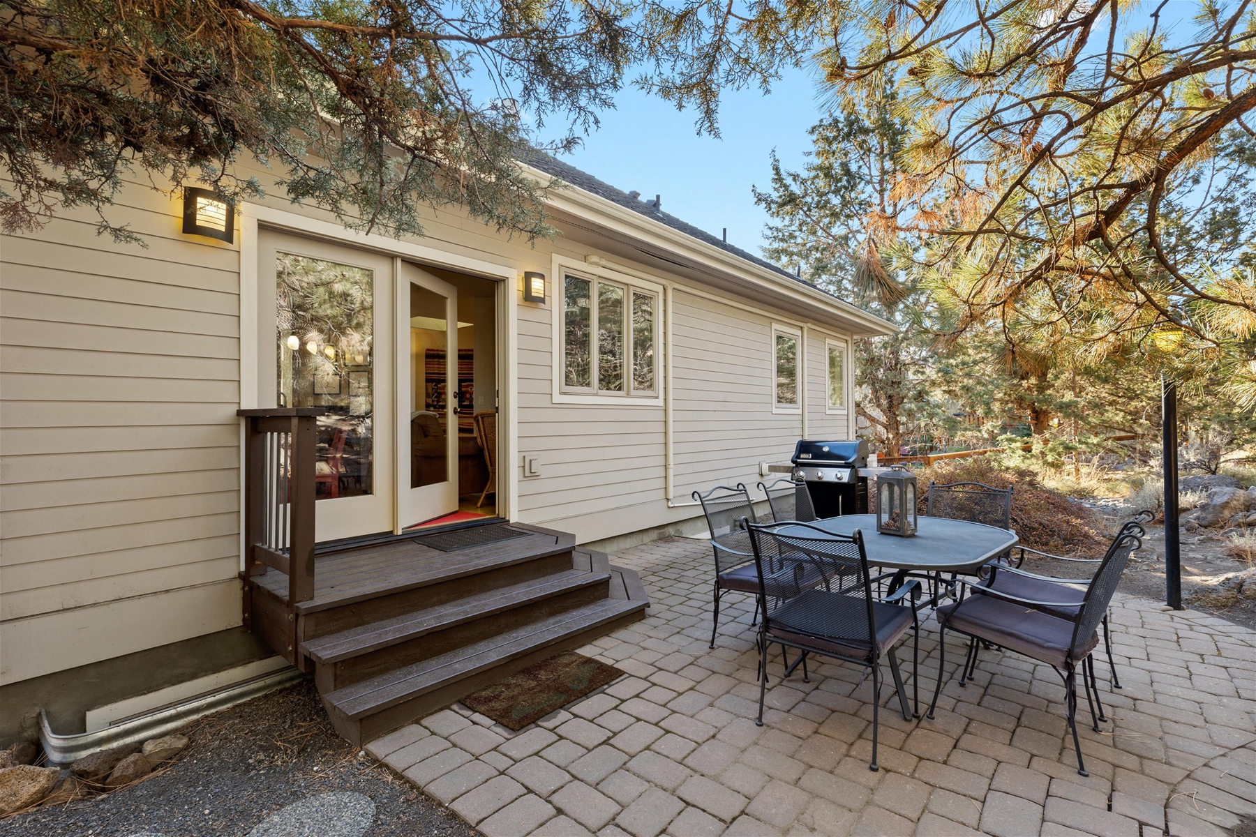 Outdoor dining area with BBQ grill.