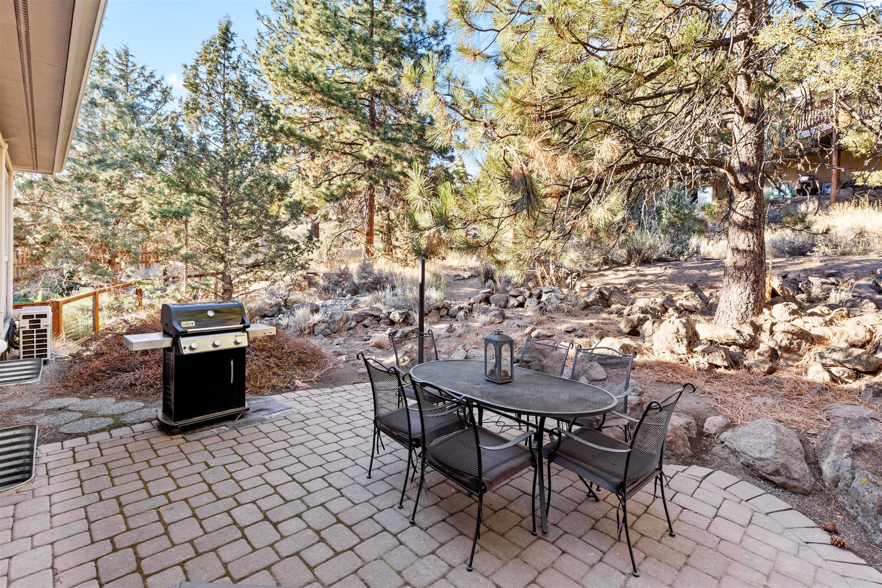 Outdoor dining area with BBQ grill.