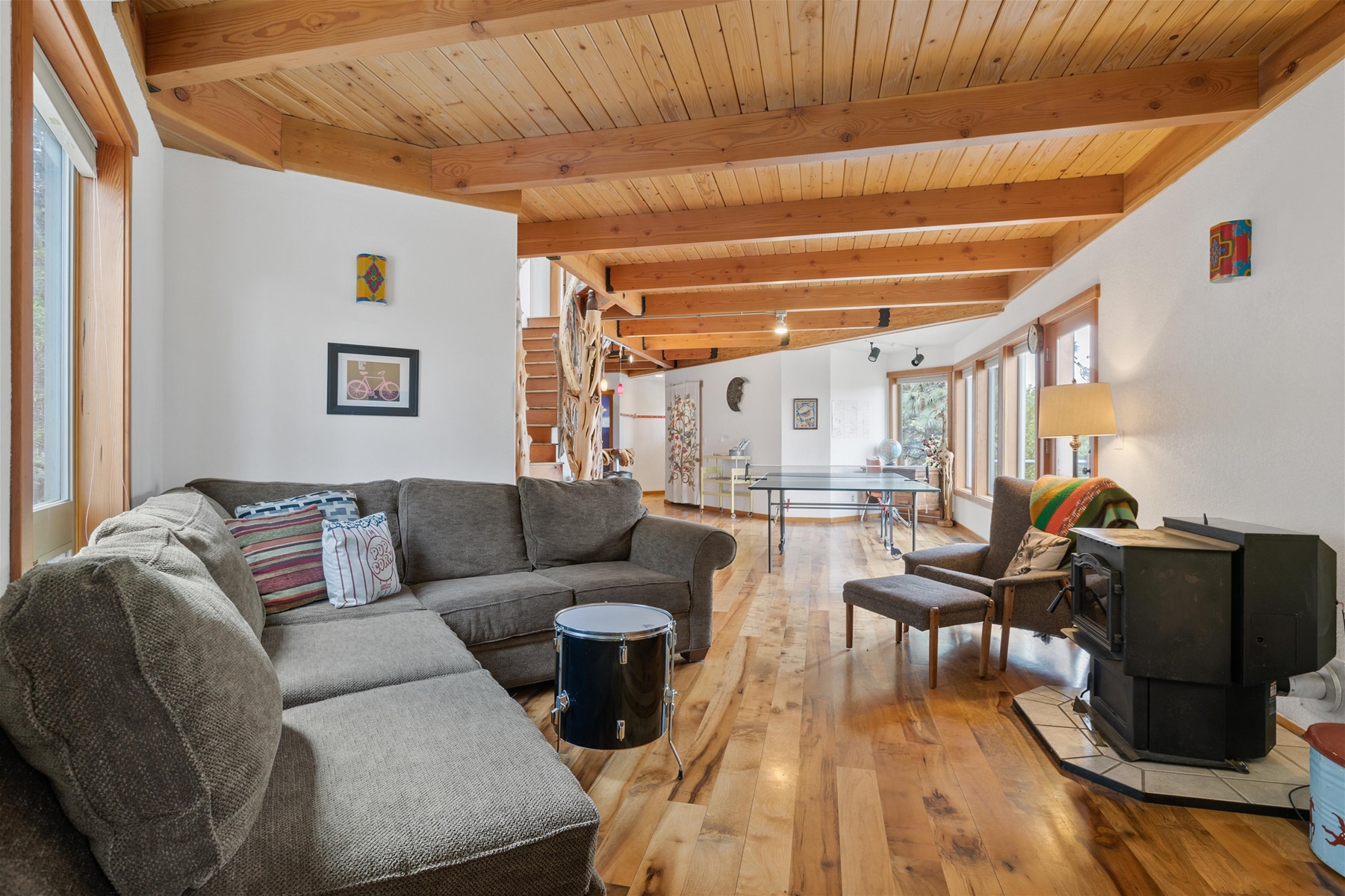 Main living room area with pellet stove and smart TV. 
