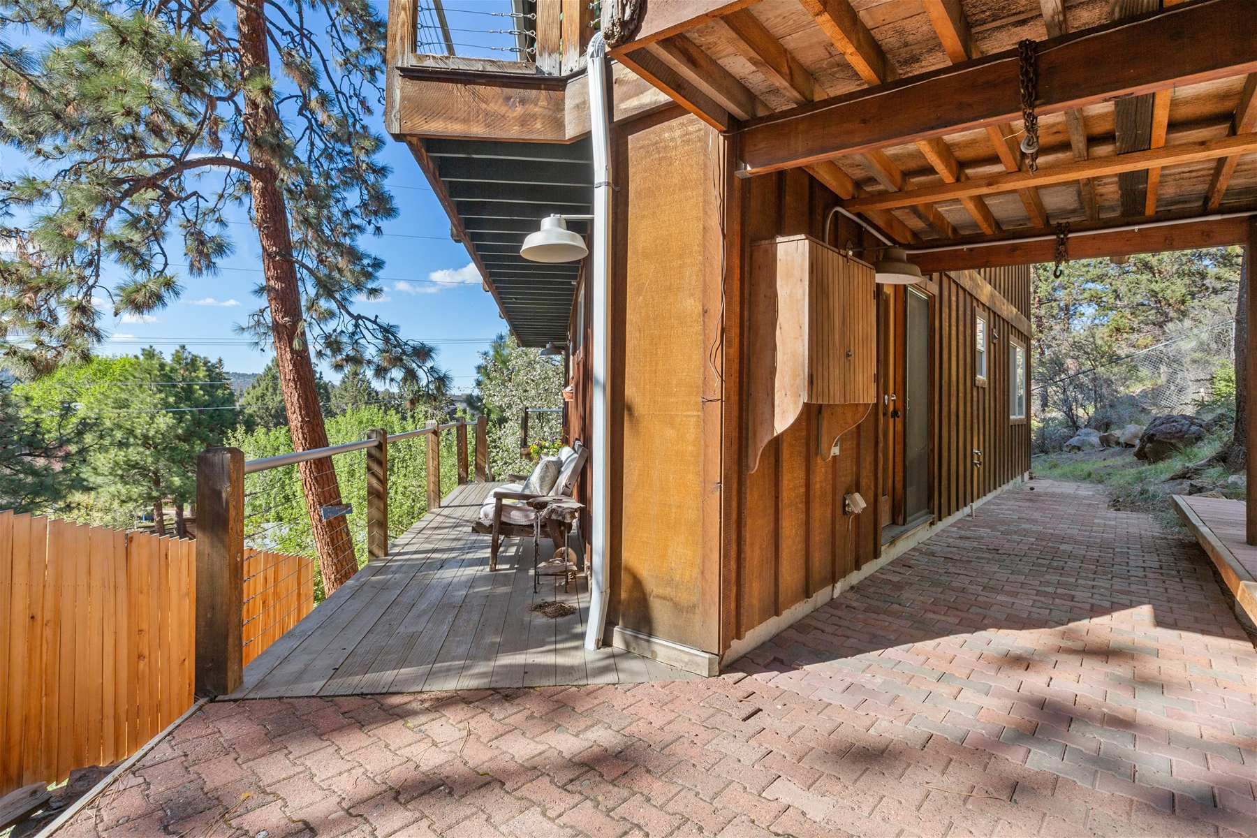 Wrap around deck in the front, paved patio off of queen guest room in the back. 