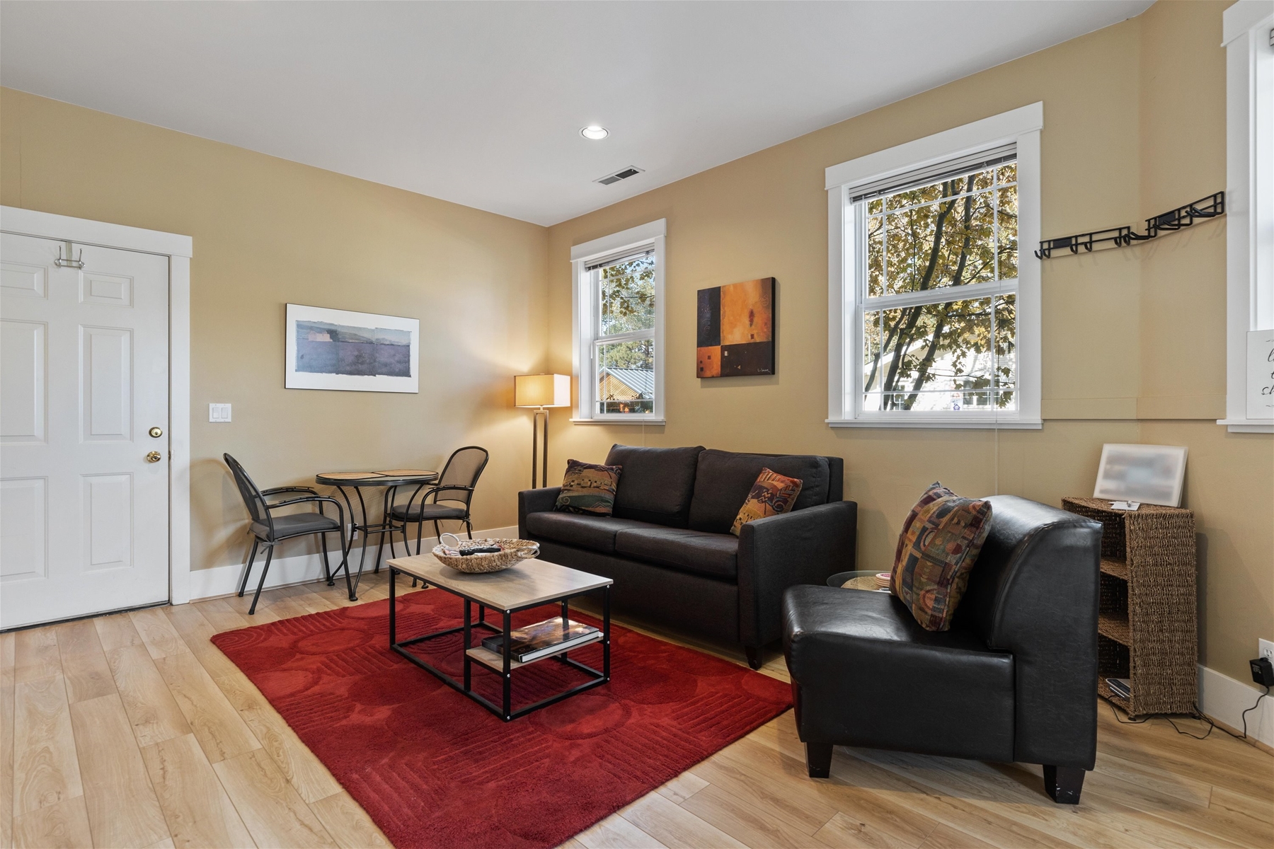 Living room area with smart TV – a small table with two chairs for morning coffee adjoins the kitchen.