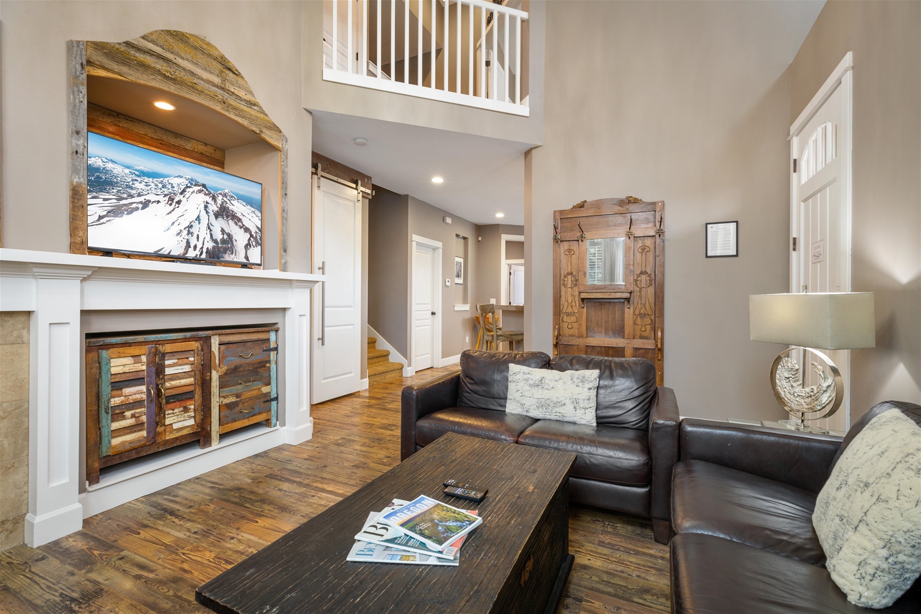 Cozy up in style- this living room is perfect for relaxation and gathering – includes a large smart TV and gas fireplace. 
