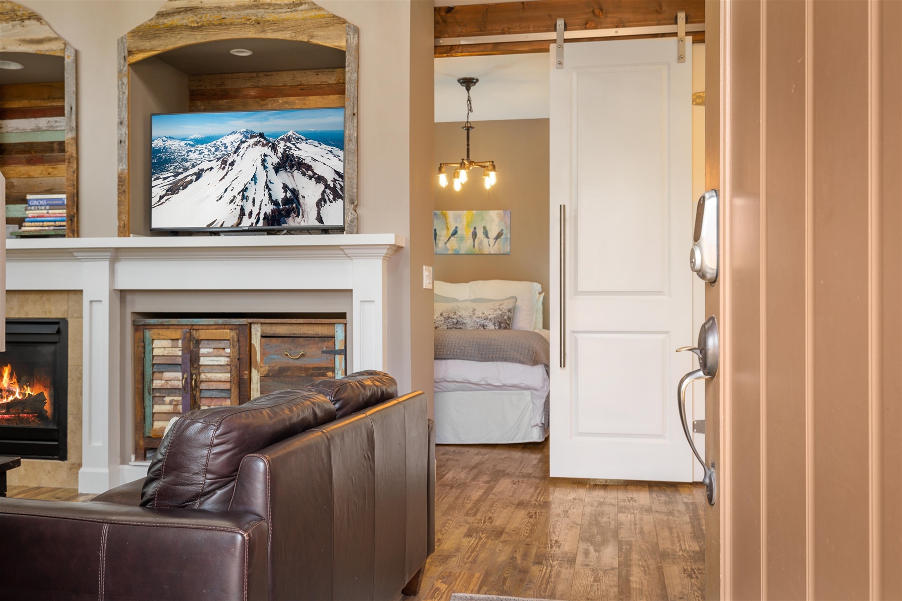 Cozy up in style- this living room is perfect for relaxation and gathering – includes a large smart TV and gas fireplace. 