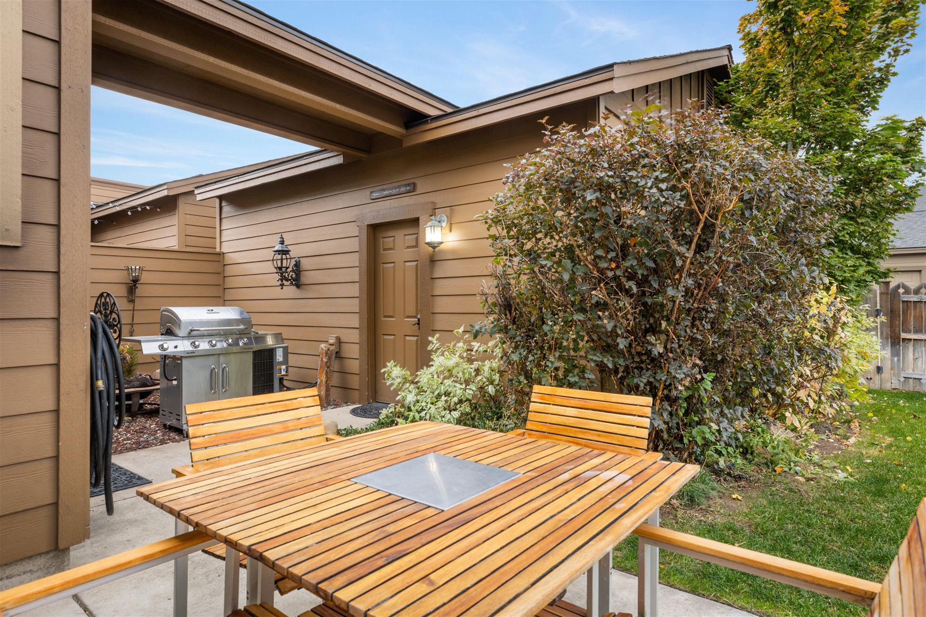 Outdoor patio seating and grill.