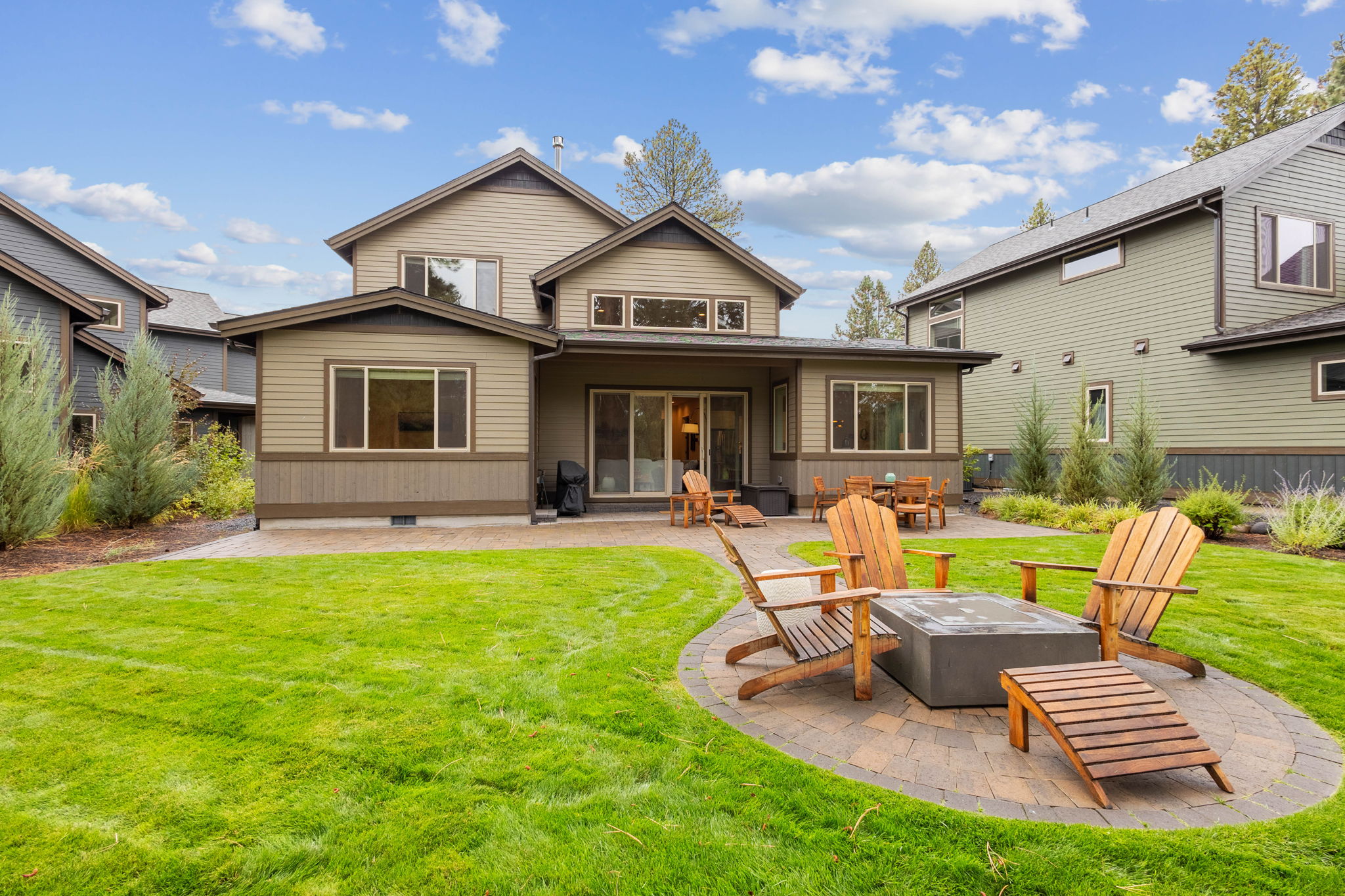 Lush backyard with natural gas firepit.