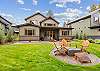Lush backyard with natural gas firepit.