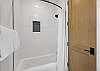 Our shared bathroom features dual vanities, with a separate door leading to a private area with the shower and toilet — offering extra privacy for multiple guests getting ready at once.