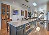 The stunning chef's kitchen has everything you need to cook up a great meal, with a large island and bar seating for 4. 