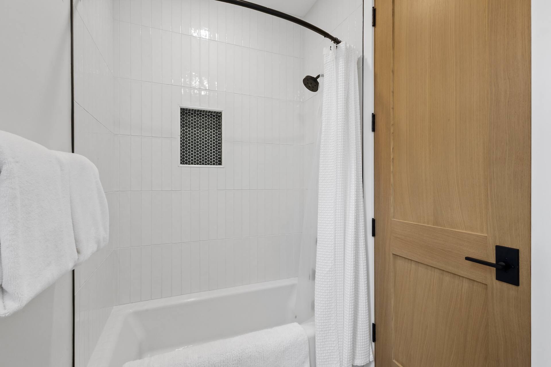 Our shared bathroom features dual vanities, with a separate door leading to a private area with the shower and toilet — offering extra privacy for multiple guests getting ready at once.